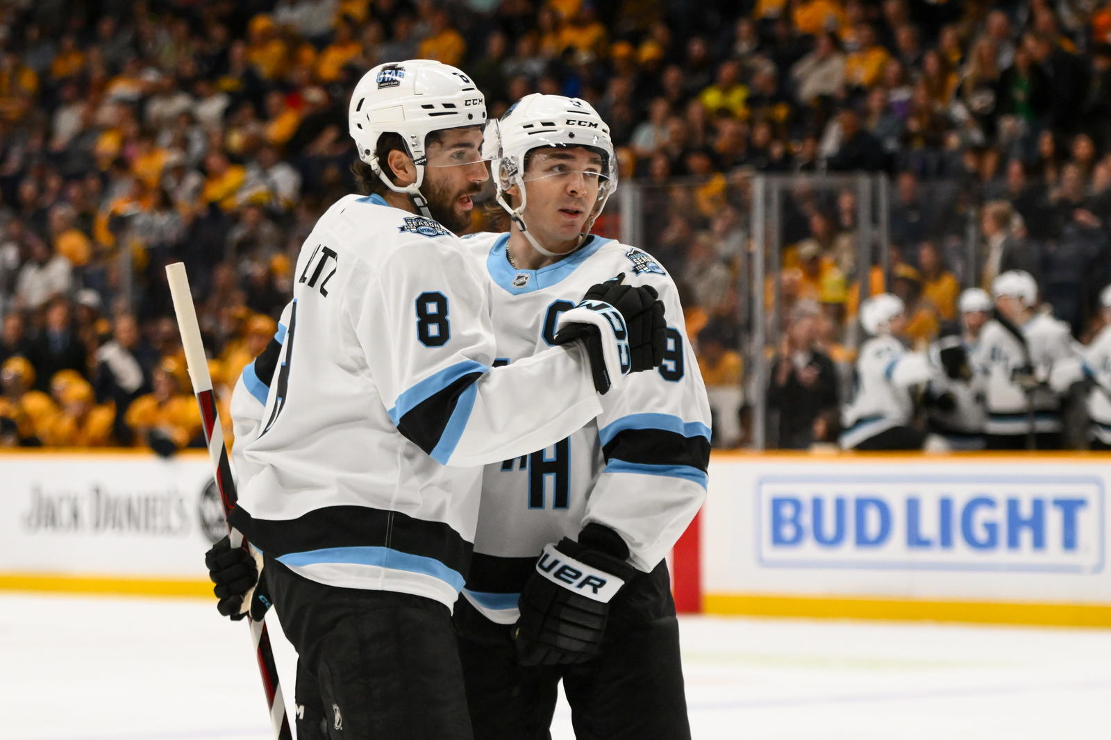 Apr 14, 2025; Nashville, Tennessee, USA; Utah Hockey Club center Nick Schmaltz (8) celebrates goal with center Clayton Keller (9) against the Nashville Predators during the second period at Bridgestone Arena. Mandatory Credit: Steve Roberts-Imagn Images