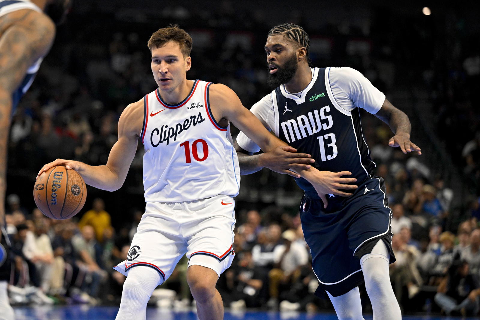 LA Clippers guard Bogdan Bogdanovic (10) brings the ball up court past Dallas Mavericks forward Naji Marshall (13) during the second quarter in an NBA Cup game at the American Airlines Center. Jerome Miron-Imagn Images