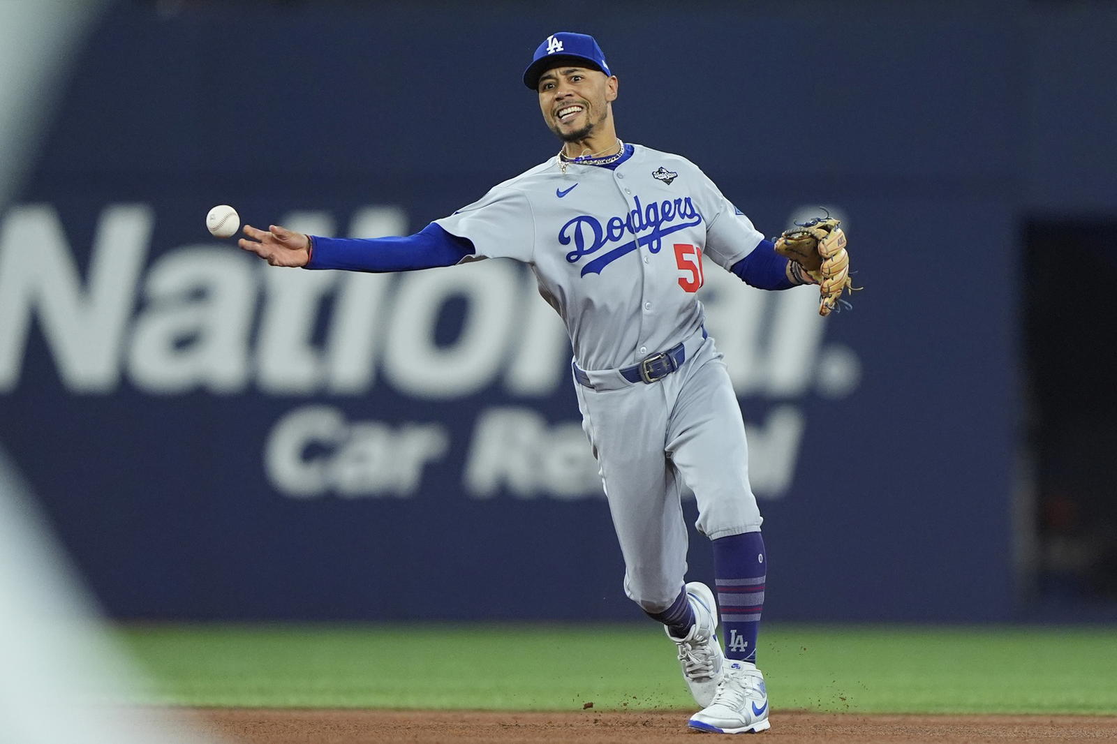 Nov 1, 2025; Toronto, Ontario, CAN; Los Angeles Dodgers shortstop Mookie Betts (50) throws to first for an out against Toronto Blue Jays third baseman Ernie Clement (22) in the fourth inning during game seven of the 2025 MLB World Series at Rogers Centre. (John E. Sokolowski/Imagn Images)