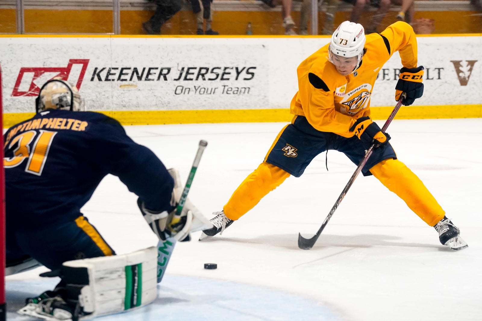 Gold team forward Ryker Lee (73) shoots towards Blue team goalie T.J. Semptimphelter (31) during the Future Stars Game at the Ford Ice Center Bellevue in Nashville, Tenn., Saturday, July 5, 2025