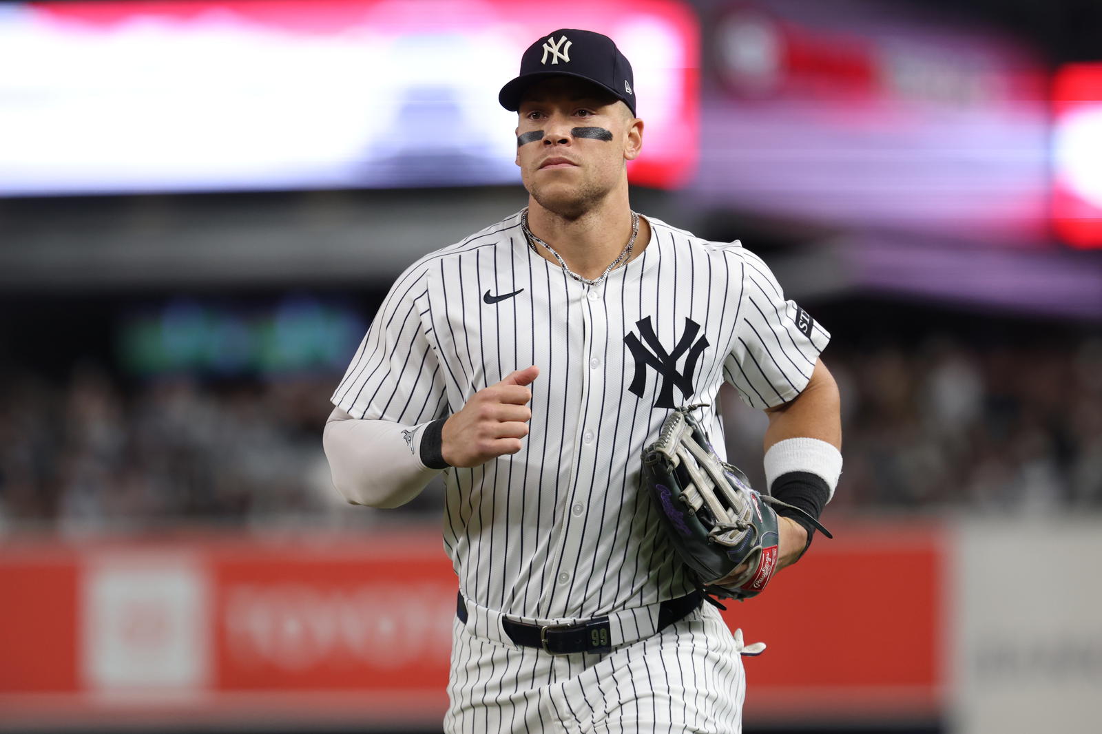New York Yankees outfielder Aaron Judge (99) heads for the dugout between innings during game three of the Wildcard round for the 2025 MLB playoffs against the Boston Red Sox at Yankee Stadium. Vincent Carchietta-Imagn Images