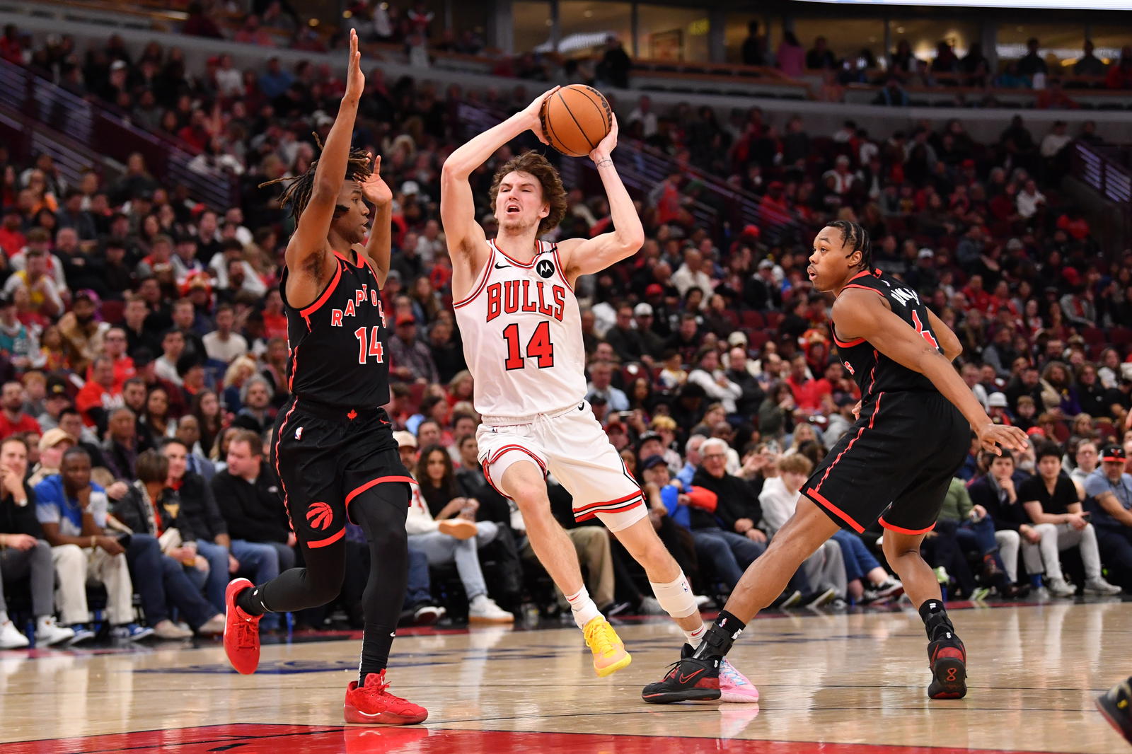 Feb 28, 2025; Chicago, Illinois, USA; Chicago Bulls forward Matas Buzelis (14) drives against Toronto Raptors guard Ja'Kobe Walter (14) during the second half at the United Center. Mandatory Credit: Patrick Gorski-Imagn Images