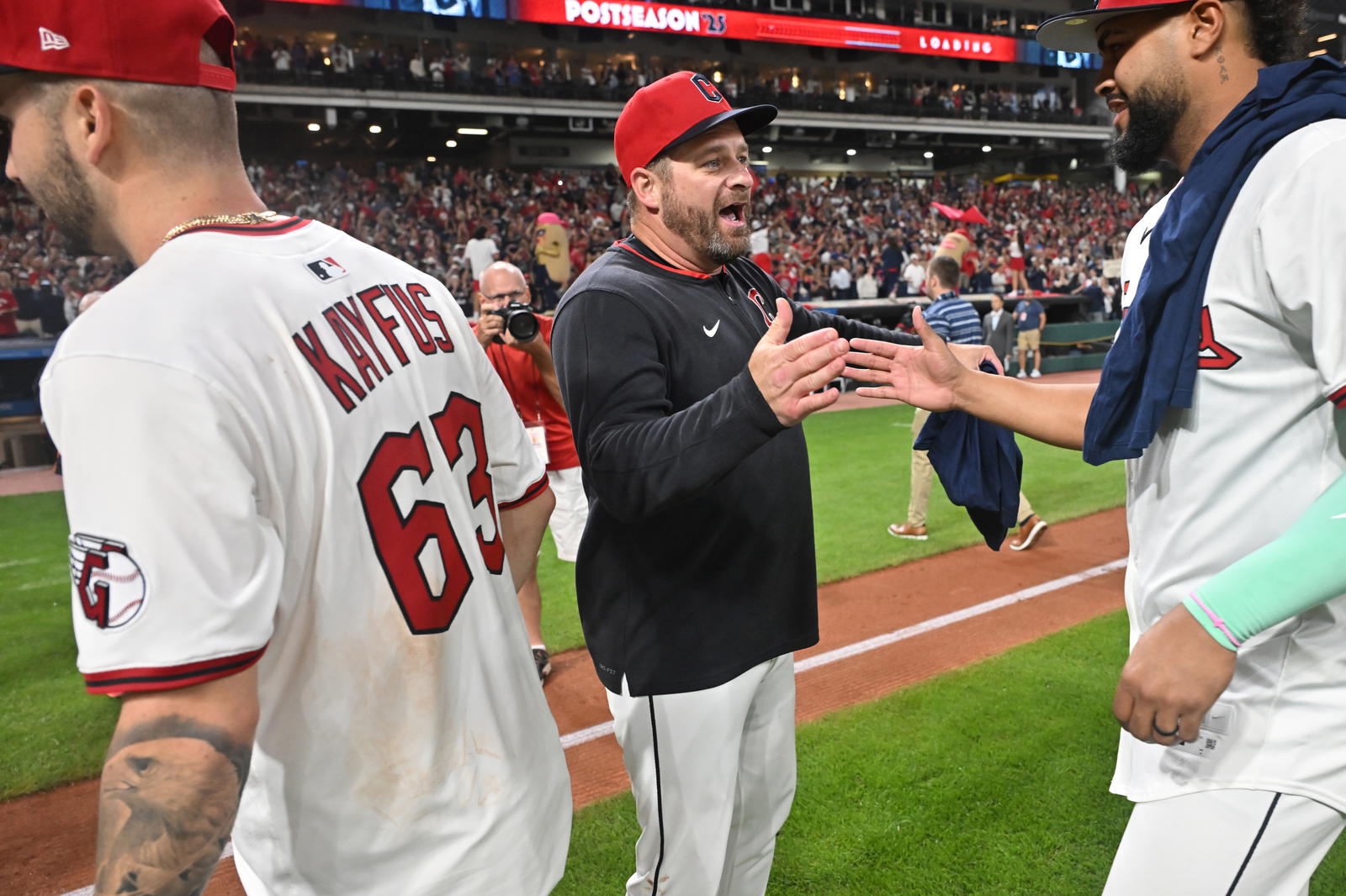 Sep 27, 2025; Cleveland, Ohio, USA; Cleveland Guardians manager Stephen Vogt (12) celebrates with right fielder Johnathan Rodriguez (30) and first baseman CJ Kayfus (63) after the Guardians beat the Texas Rangers to secure a playoff berth at Progressive Field. Mandatory Credit: Ken Blaze-Imagn Images