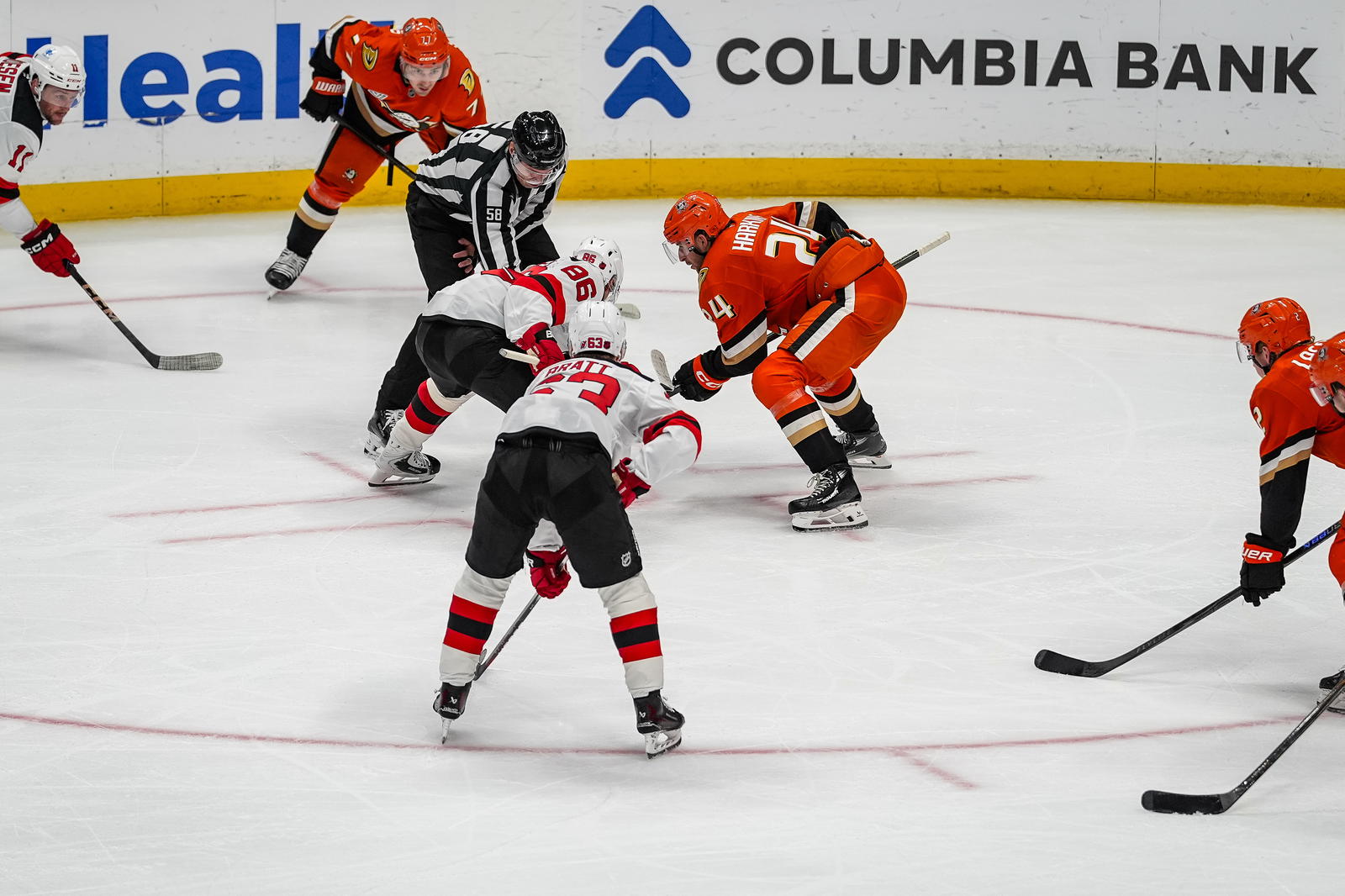 Nov 2, 2025; Anaheim, California, USA; New Jersey Devils center Jack Hughes (86) faces off against Anaheim Ducks center Jansen Harkins (24) during the second period at Honda Center. Mandatory Credit: Corinne Votaw-Imagn Images