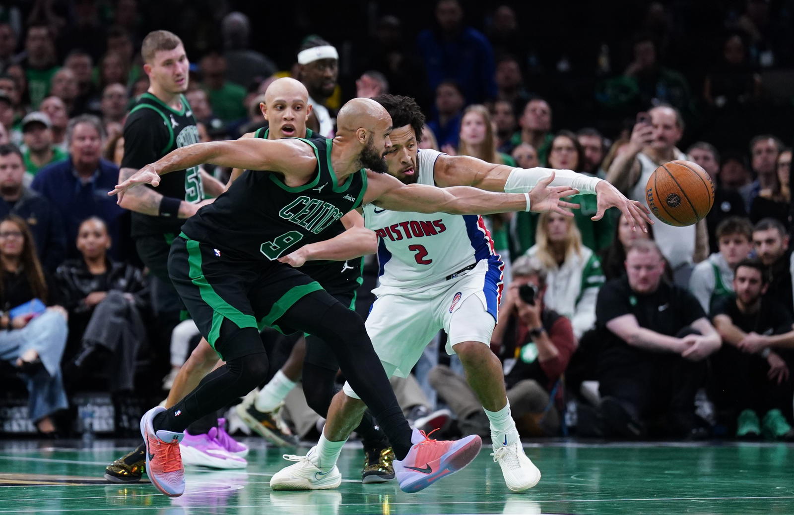 Nov 26, 2025; Boston, Massachusetts, USA; Detroit Pistons guard Cade Cunningham (2) and Boston Celtics guard Derrick White (9) work for the ball in the last seconds of the fourth quarter at TD Garden. (David Butler II/Imagn Images)