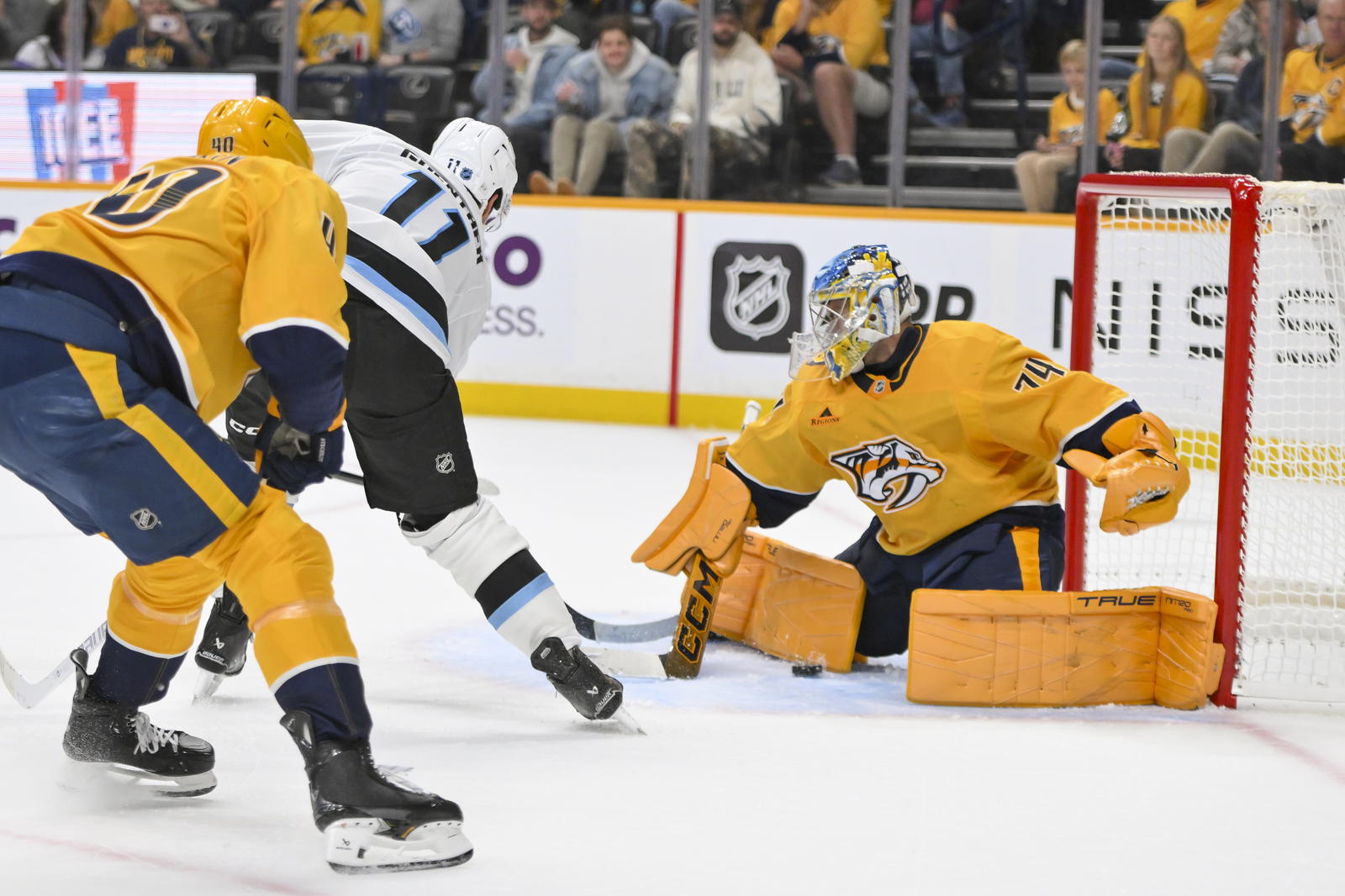 Oct 11, 2025; Nashville, Tennessee, USA; Utah Mammoth right wing Dylan Guenther (11) scores the game winner past Nashville Predators goaltender Juuse Saros (74) during the overtime period at Bridgestone Arena. Mandatory Credit: Steve Roberts-Imagn Images