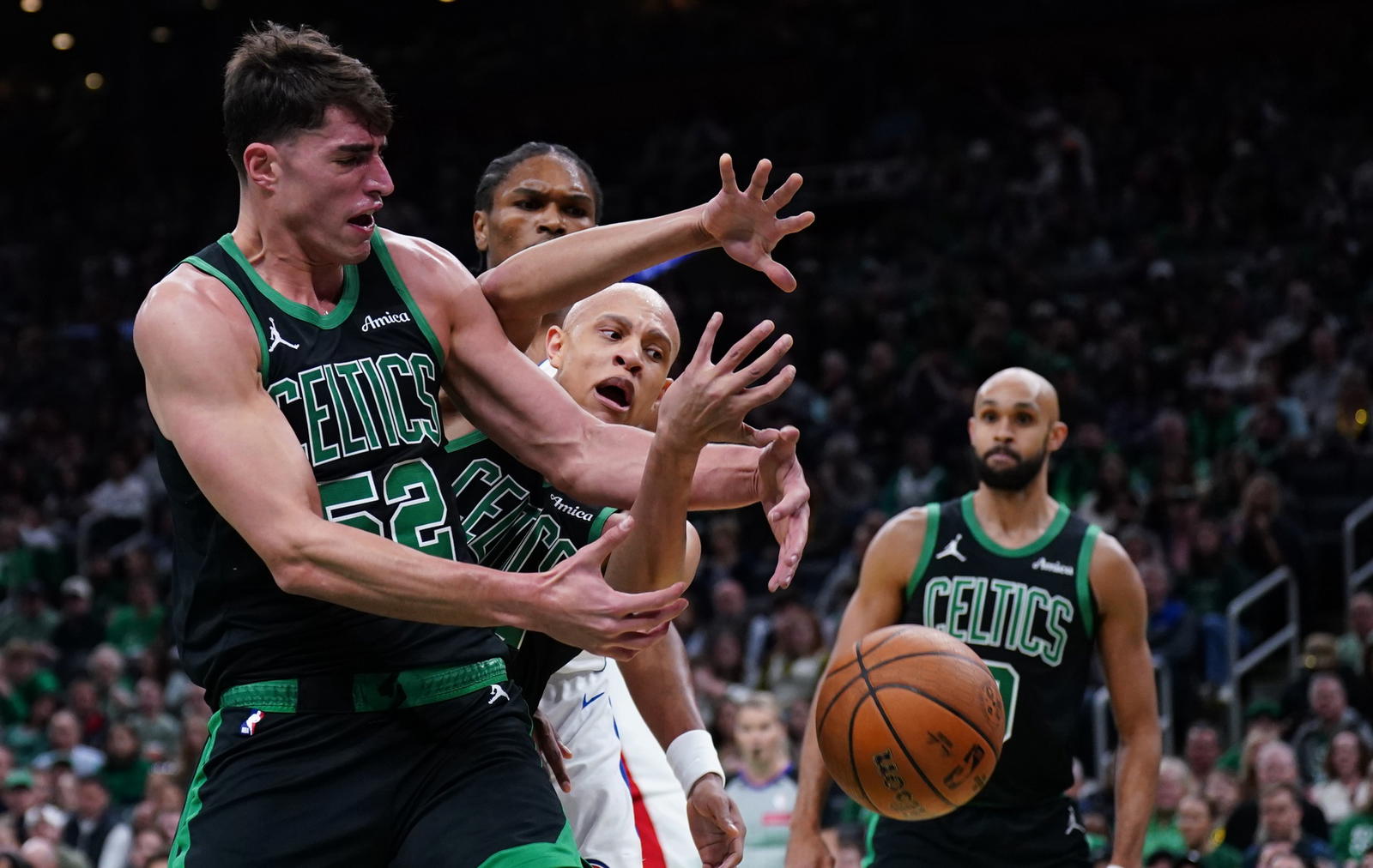 Nov 26, 2025; Boston, Massachusetts, USA; Boston Celtics center Luka Garza (52) and guard Jordan Walsh (27) work for the ball against the Detroit Pistons in the first quarter at TD Garden. (David Butler II/Imagn Images)