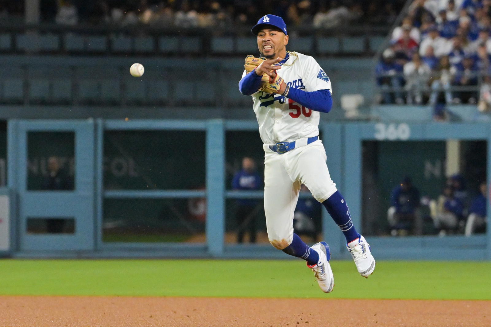 Oct 8, 2025; Los Angeles, California, USA; Los Angeles Dodgers shortstop Mookie Betts (50) makes a throw to first for an out during the third inning against the Philadelphia Phillies during game three of the NLDS round for the 2025 MLB playoffs at Dodger Stadium. (Jayne Kamin Oncea/Imagn Images)
