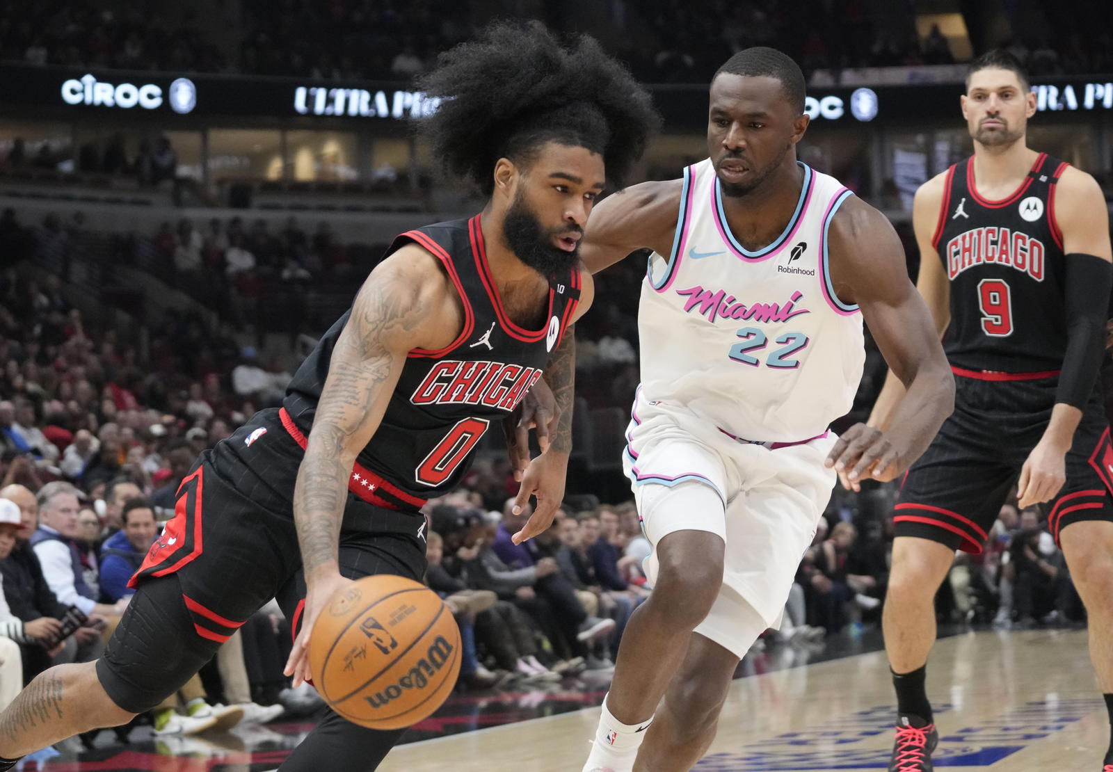 Apr 9, 2025; Chicago, Illinois, USA; Miami Heat forward Andrew Wiggins (22) defends Chicago Bulls guard Coby White (0) during the first quarter at United Center. Mandatory Credit: David Banks-Imagn Images