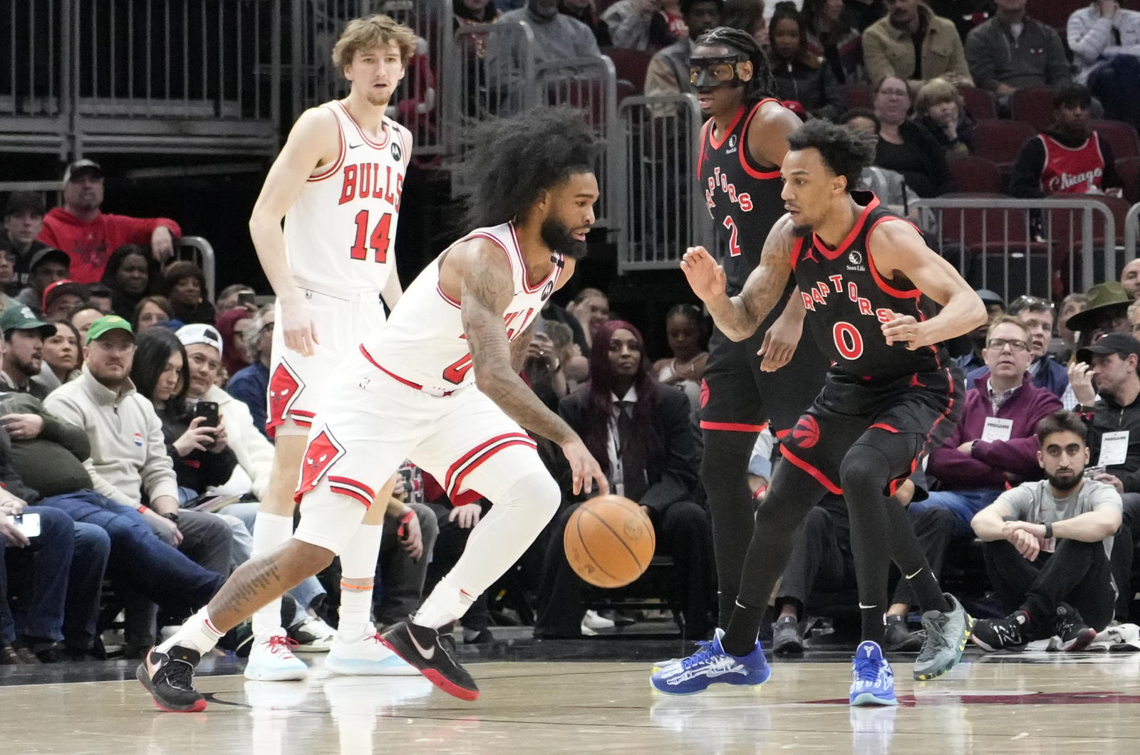 Apr 1, 2025; Chicago, Illinois, USA; Chicago Bulls guard Coby White (0) drives on Toronto Raptors guard A.J. Lawson (0) during the first quarter at United Center. Mandatory Credit: David Banks-Imagn Images