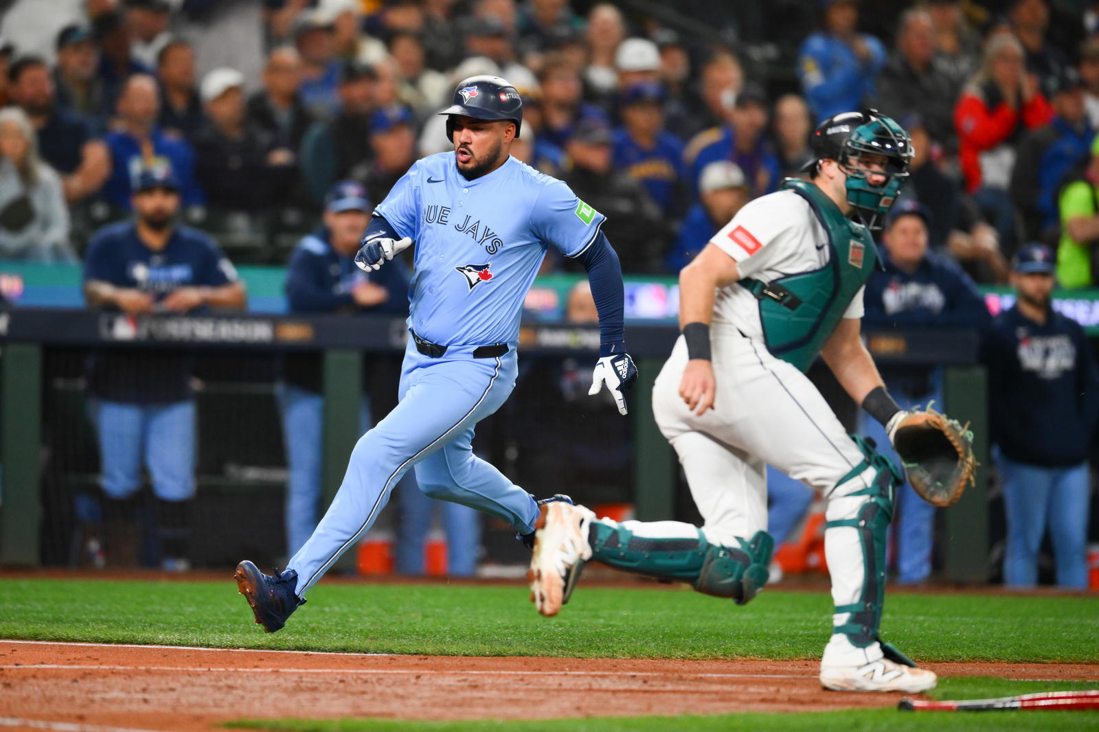 Toronto Blue Jays right fielder Anthony Santander (25) scores on a single from Toronto Blue Jays second baseman Ernie Clement (22) (not pictured) during the fifth inning against the Seattle Mariners during game three of the ALCS round for the 2025 MLB playoffs at T-Mobile Park. Steven Bisig-Imagn Images