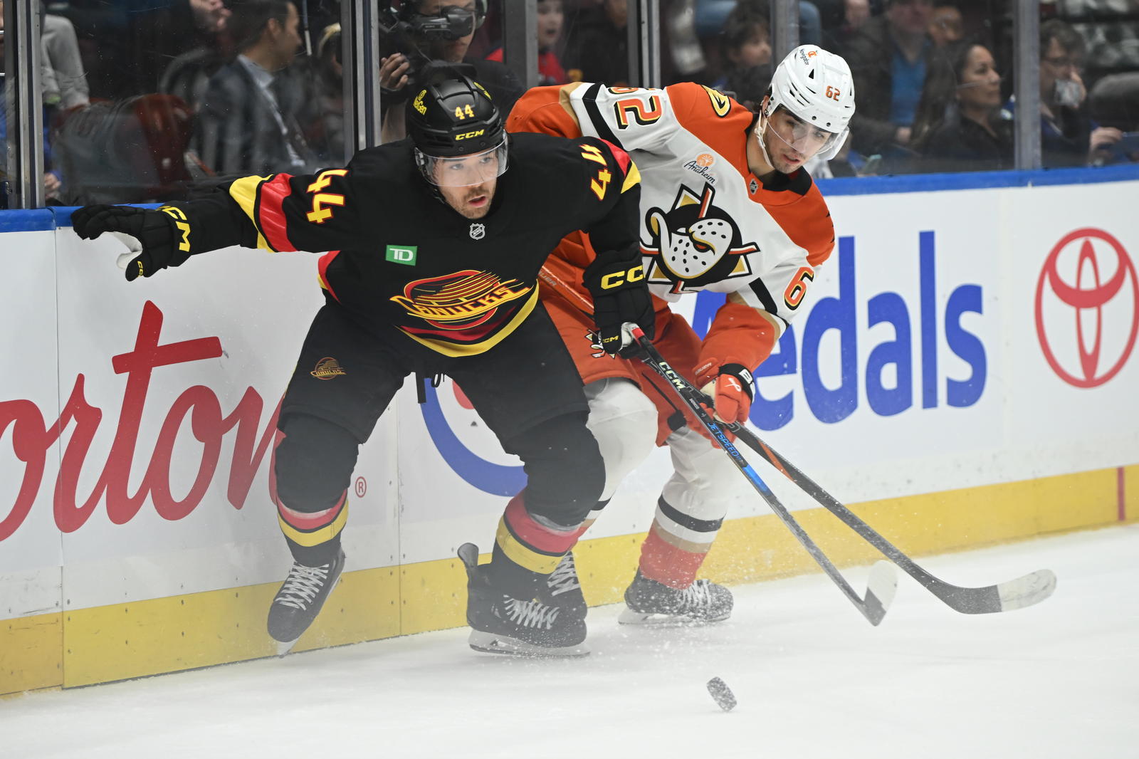 Apr 5, 2025; Vancouver, British Columbia, CAN; Vancouver Canucks forward Kiefer Sherwood (44) battles for the puck against Anaheim Ducks forward Nikita Nesterenko (62) during the third period at Rogers Arena. Mandatory Credit: Anne-Marie Sorvin-Imagn Images
