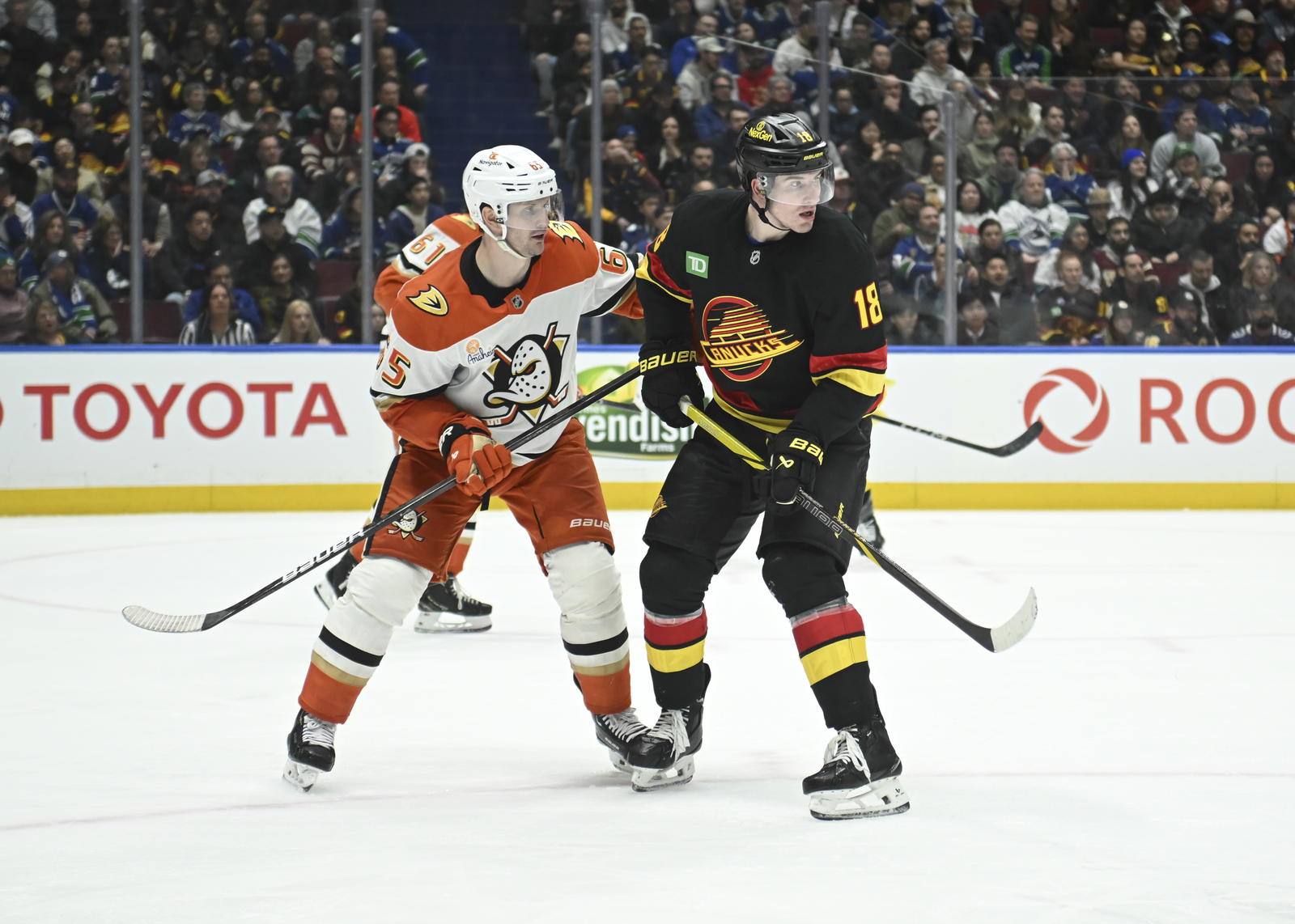 Mar 5, 2025; Vancouver, British Columbia, CAN; Anaheim Ducks defenseman Jacob Trouba (65) check Vancouver Canucks forward Drew O'Connor (18) during the second period at Rogers Arena. Mandatory Credit: Simon Fearn-Imagn Images