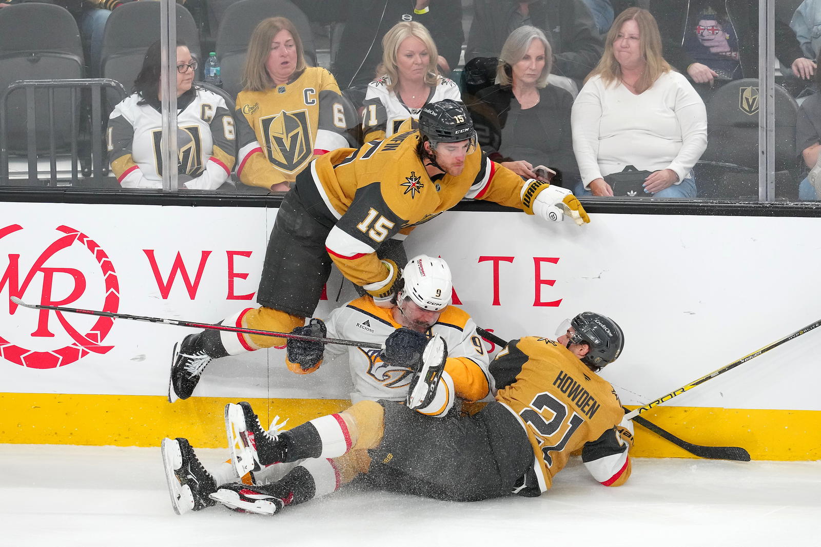 <i>Golden Knights defenseman Noah Hanifin (15) and Vegas Golden Knights center Brett Howden (21) collide with Predators left wing Filip Forsberg (9) during the third period of an NHL game at T-Mobile Arena on April 12, 2025. <b>Photo Credit: Stephen R. Sylvanie-Imagn Images</b></i>