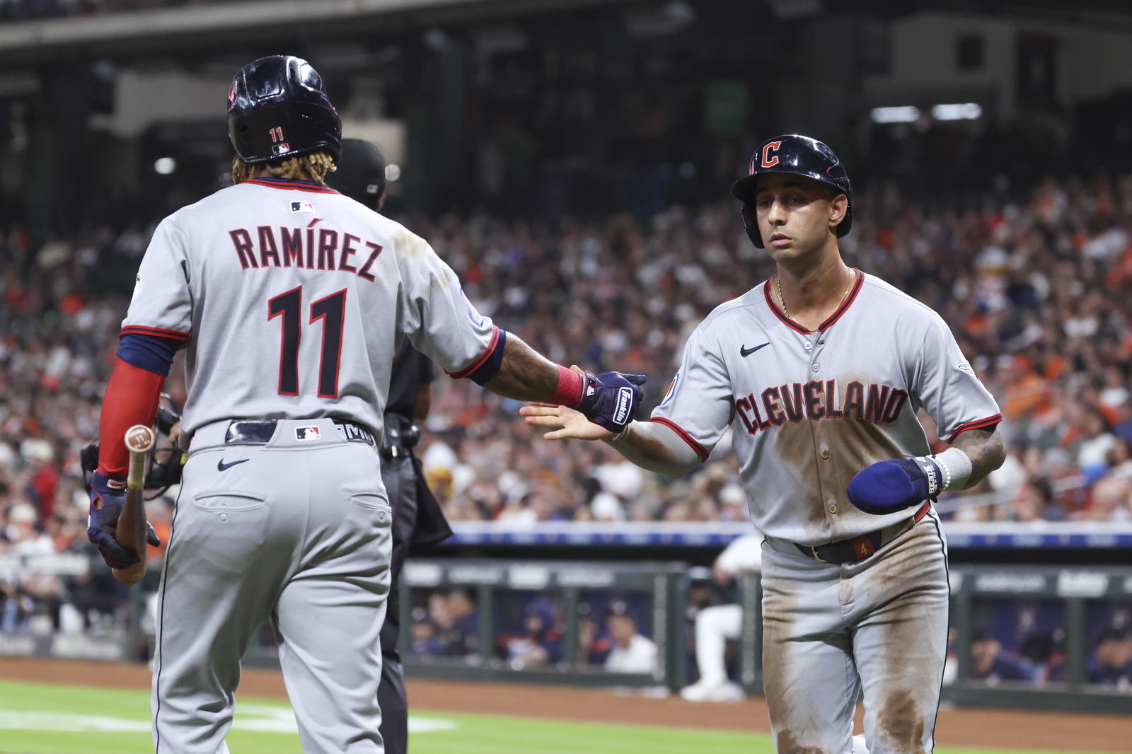 Jul 8, 2025; Houston, Texas, USA; Cleveland Guardians shortstop Brayan Rocchio (4) celebrates with designated hitter Jose Ramirez (11) after scoring during the third inning against the Houston Astros at Daikin Park. Mandatory Credit: Troy Taormina-Imagn Images