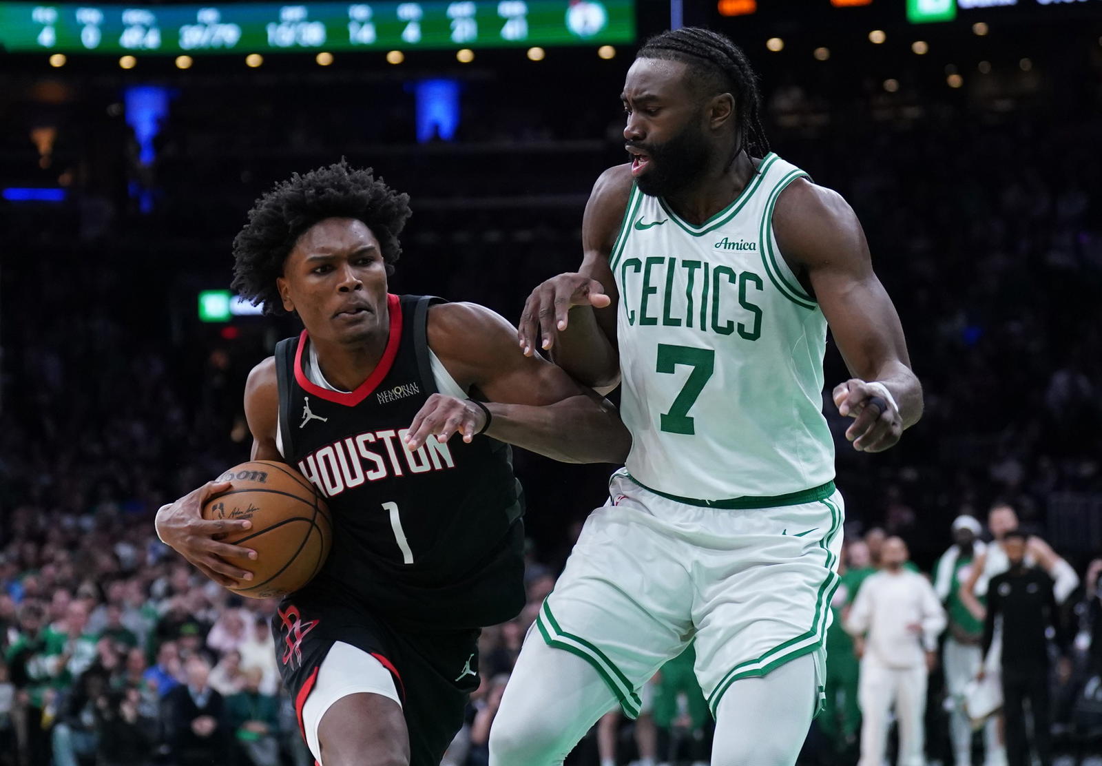 Jan 27, 2025; Boston, Massachusetts, USA; Houston Rockets forward Amen Thompson (1) drives the ball to the basket against Boston Celtics guard Jaylen Brown (7) in the last seconds of then game at TD Garden. (David Butler II/Imagn Images)