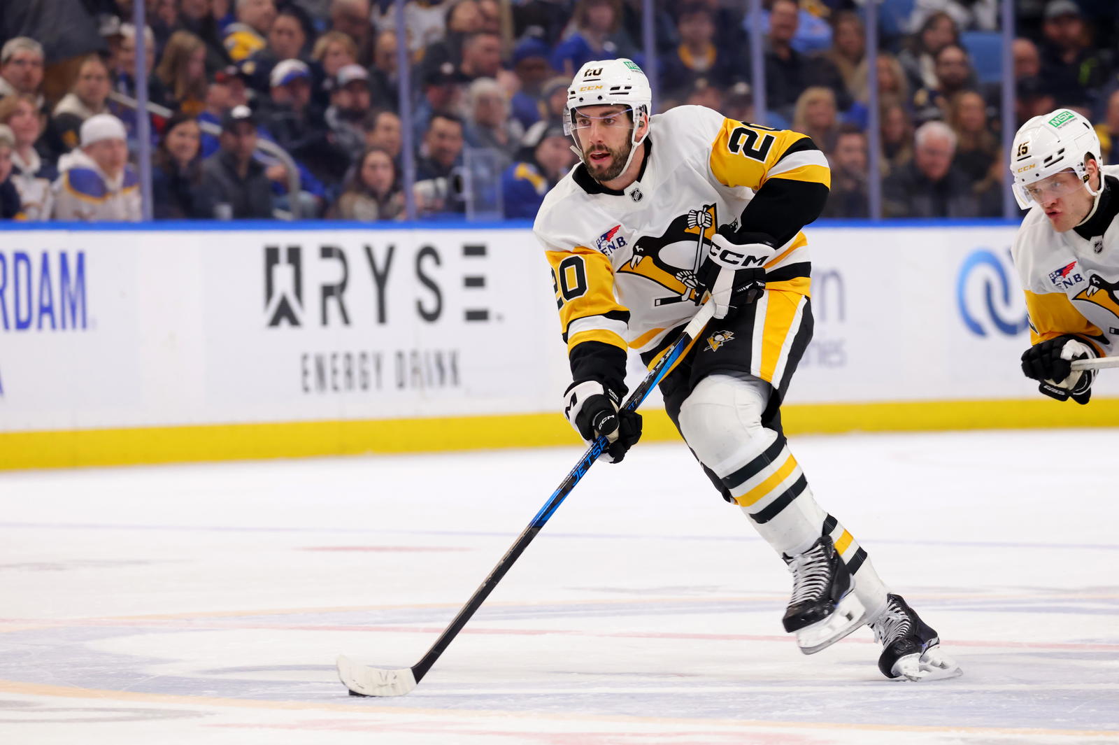 Mar 27, 2025; Buffalo, New York, USA; Pittsburgh Penguins defenseman Conor Timmins (20) skates up ice with the puck during the first period against the Buffalo Sabres at KeyBank Center. Mandatory Credit: Timothy T. Ludwig-Imagn Images