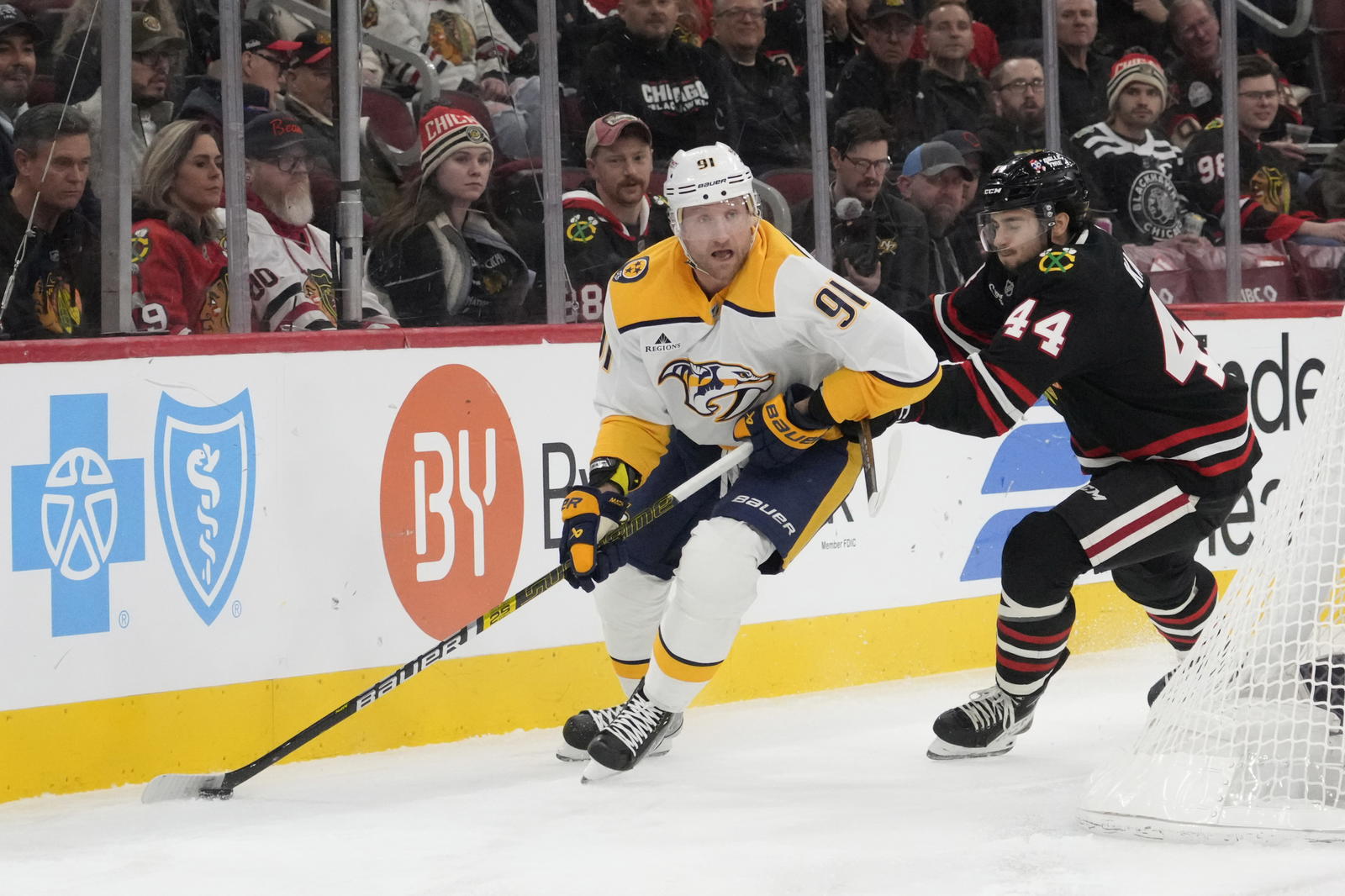 Nov 28, 2025; Chicago, Illinois, USA; Nashville Predators center Steven Stamkos (91) controls the puck against Chicago Blackhawks defenseman Wyatt Kaiser (44) during the first period at United Center. Mandatory Credit: David Banks-Imagn Images
