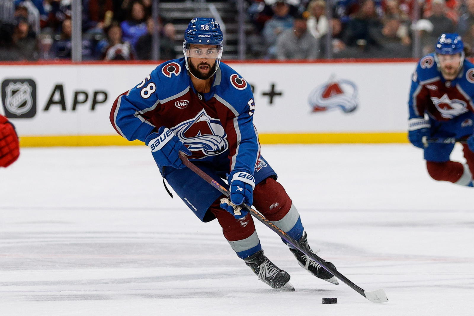 Feb 26, 2025; Denver, Colorado, USA; Colorado Avalanche defenseman Oliver Kylington (58) controls the puck in the third period against the New Jersey Devils at Ball Arena. Mandatory Credit: Isaiah J. Downing-Imagn Images