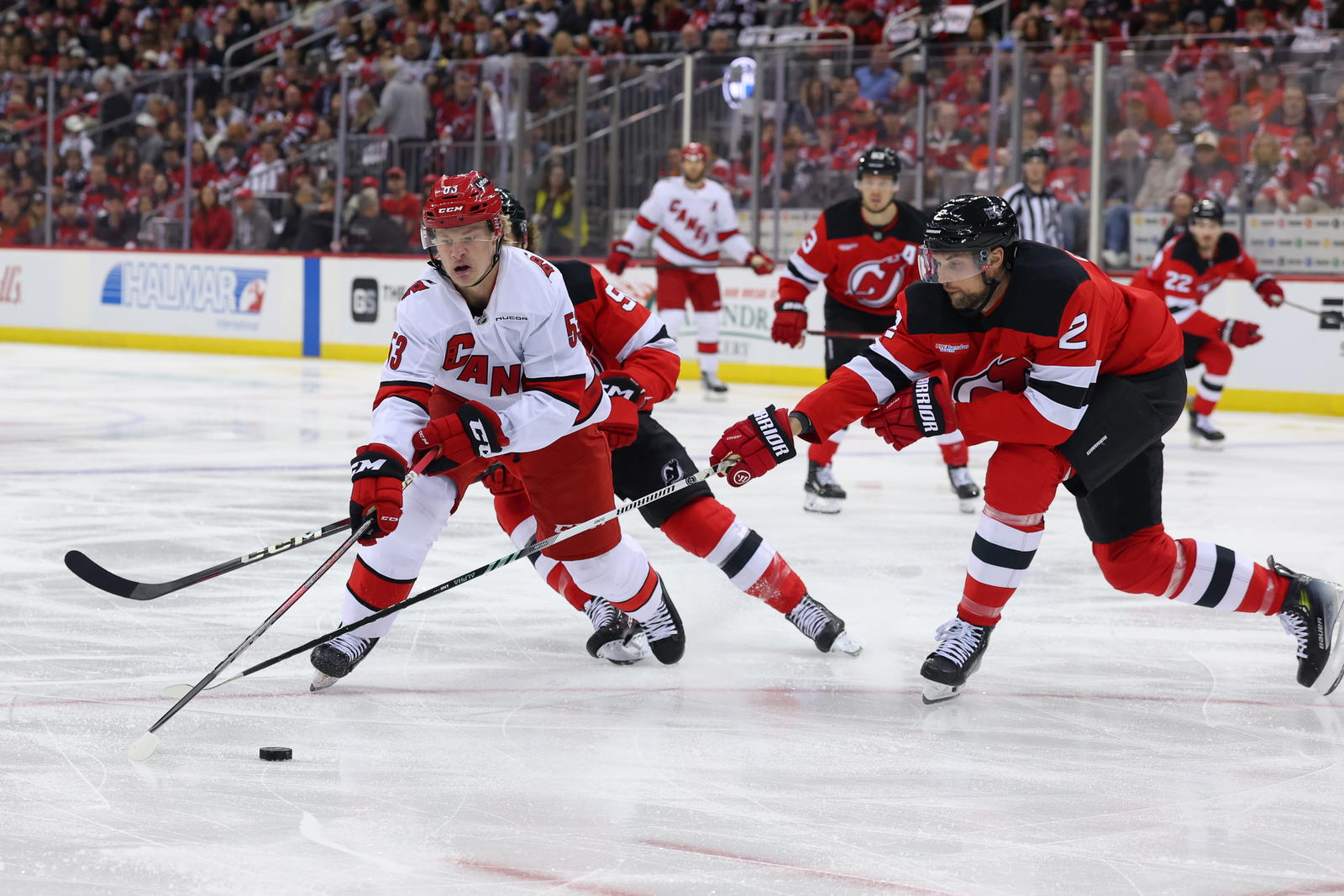 Apr 27, 2025; Newark, New Jersey, USA; Carolina Hurricanes right wing Jackson Blake (53) skates with the puck as New Jersey Devils defenseman Brian Dumoulin (2) defends during the first period in game four of the first round of the 2025 Stanley Cup Playoffs at Prudential Center. Mandatory Credit: Ed Mulholland-Imagn Images