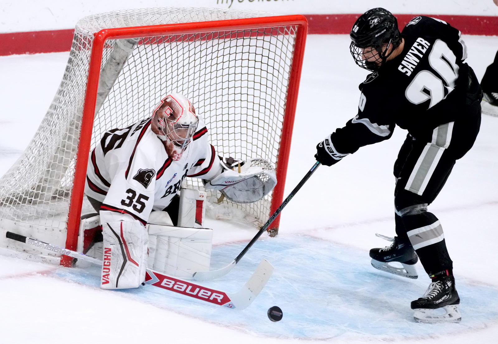 Providence College vs. Brown in annual Mayor's Cup game at Meehan auditorium on Jan7, 2025. Brown goalie Tyler Shea blocks a shot by Providence's Logan Sawyer.
