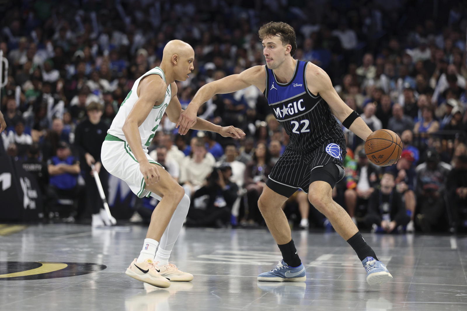 Nov 7, 2025; Orlando, Florida, USA; Orlando Magic forward Franz Wagner (22) is guarded by Boston Celtics guard Jordan Walsh (27) in the third quarter at Kia Center. (Nathan Ray Seebeck/Imagn Images)
