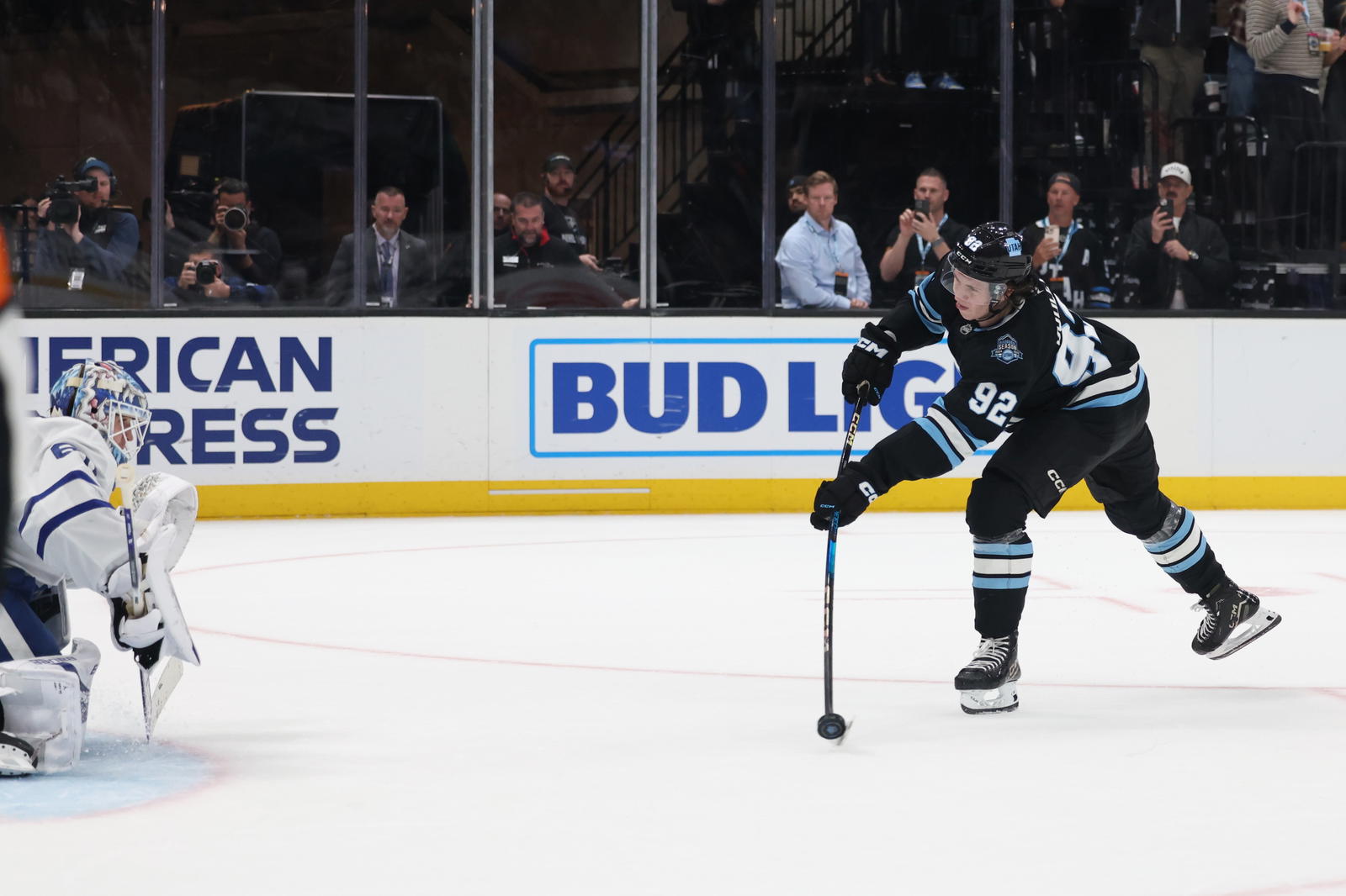 Mar 10, 2025; Salt Lake City, Utah, USA; Utah Hockey Club center Logan Cooley (92) takes a shot on Toronto Maple Leafs goaltender Joseph Woll (60) during the overtime shootout at Delta Center. Mandatory Credit: Rob Gray-Imagn Images