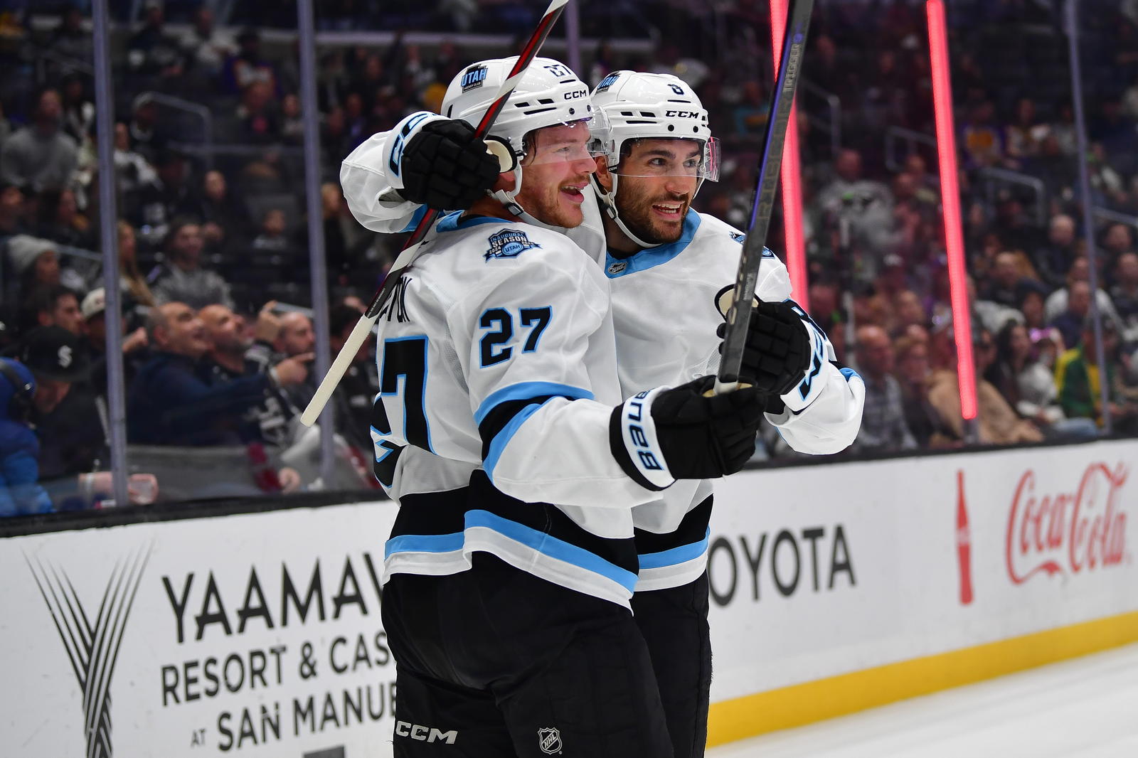 Feb 22, 2025; Los Angeles, California, USA; Utah Hockey Club center Barrett Hayton (27) celebrates his power play goal scored against the Los Angeles Kings with center Nick Schmaltz (8) during the first period at Crypto.com Arena. Mandatory Credit: Gary A. Vasquez-Imagn Images