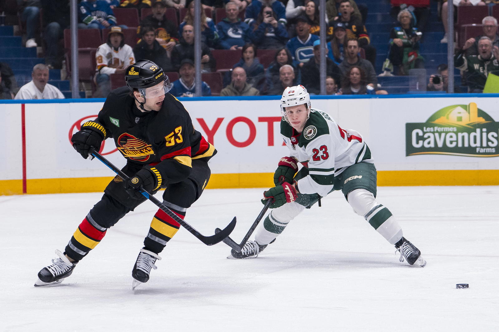 Mar 7, 2025; Vancouver, British Columbia, CAN; Minnesota Wild forward Marco Rossi (23) stick checks Vancouver Canucks forward Teddy Blueger (53) during the first period at Rogers Arena. Mandatory Credit: Bob Frid-Imagn Images