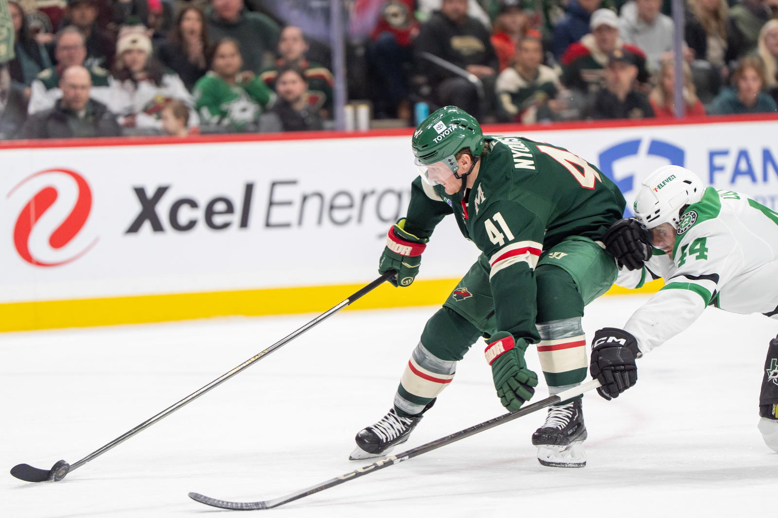 Apr 6, 2025; Saint Paul, Minnesota, USA; Dallas Stars defenseman Cody Ceci (44) dives to check Minnesota Wild center Gustav Nyquist (41) in the second period at Xcel Energy Center. Mandatory Credit: Matt Blewett-Imagn Images.