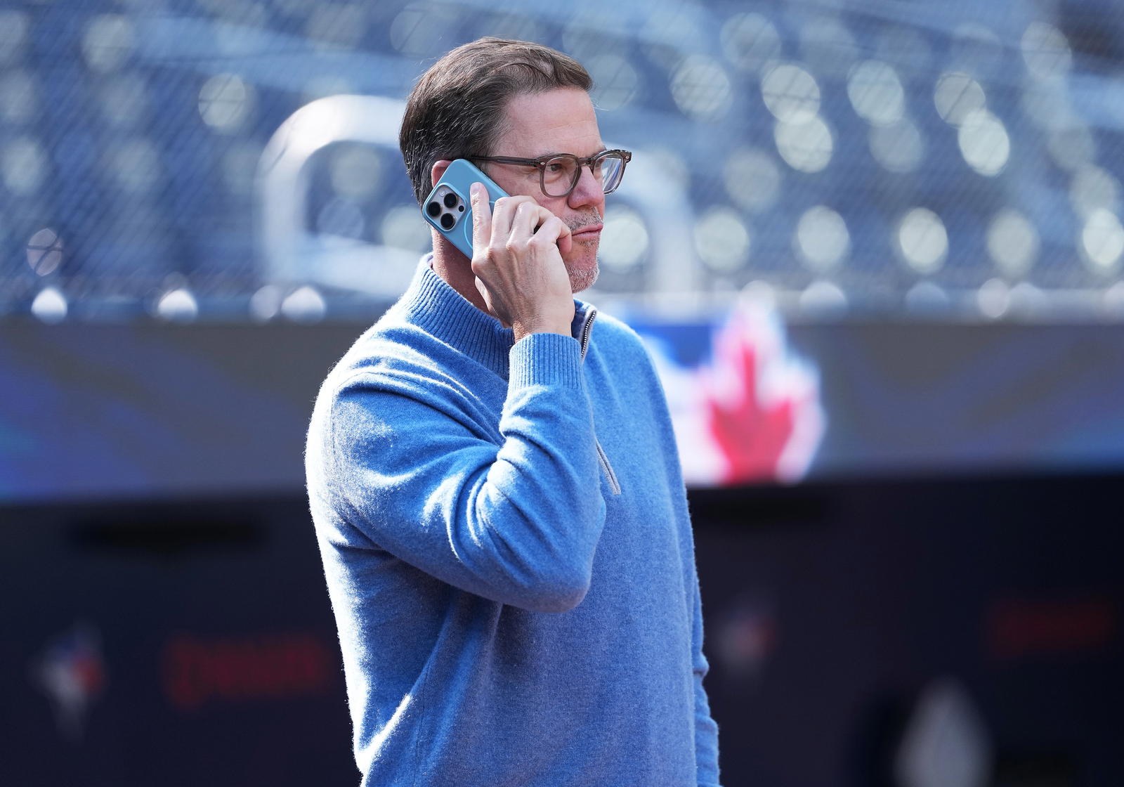 Toronto Blue Jays general manager Ross Atkins talks on the phone during batting practice before a game against the Baltimore Orioles at Rogers Centre in 2025. Nick Turchiaro-Imagn Images