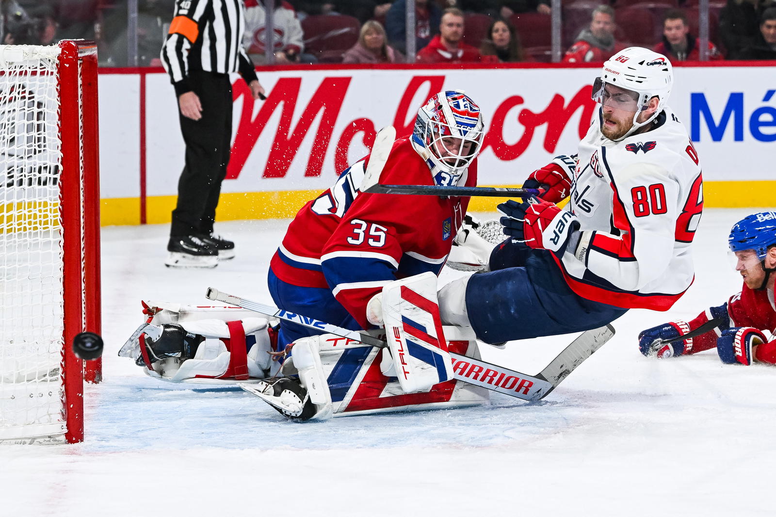 Dec 7, 2024; Montreal, Quebec, CAN; Washington Capitals left wing Pierre-Luc Dubois (80) misses a shot as he falls on Montreal Canadiens goalie Sam Montembeault (35) during the third period at Bell Centre. Mandatory Credit: David Kirouac-Imagn Images
