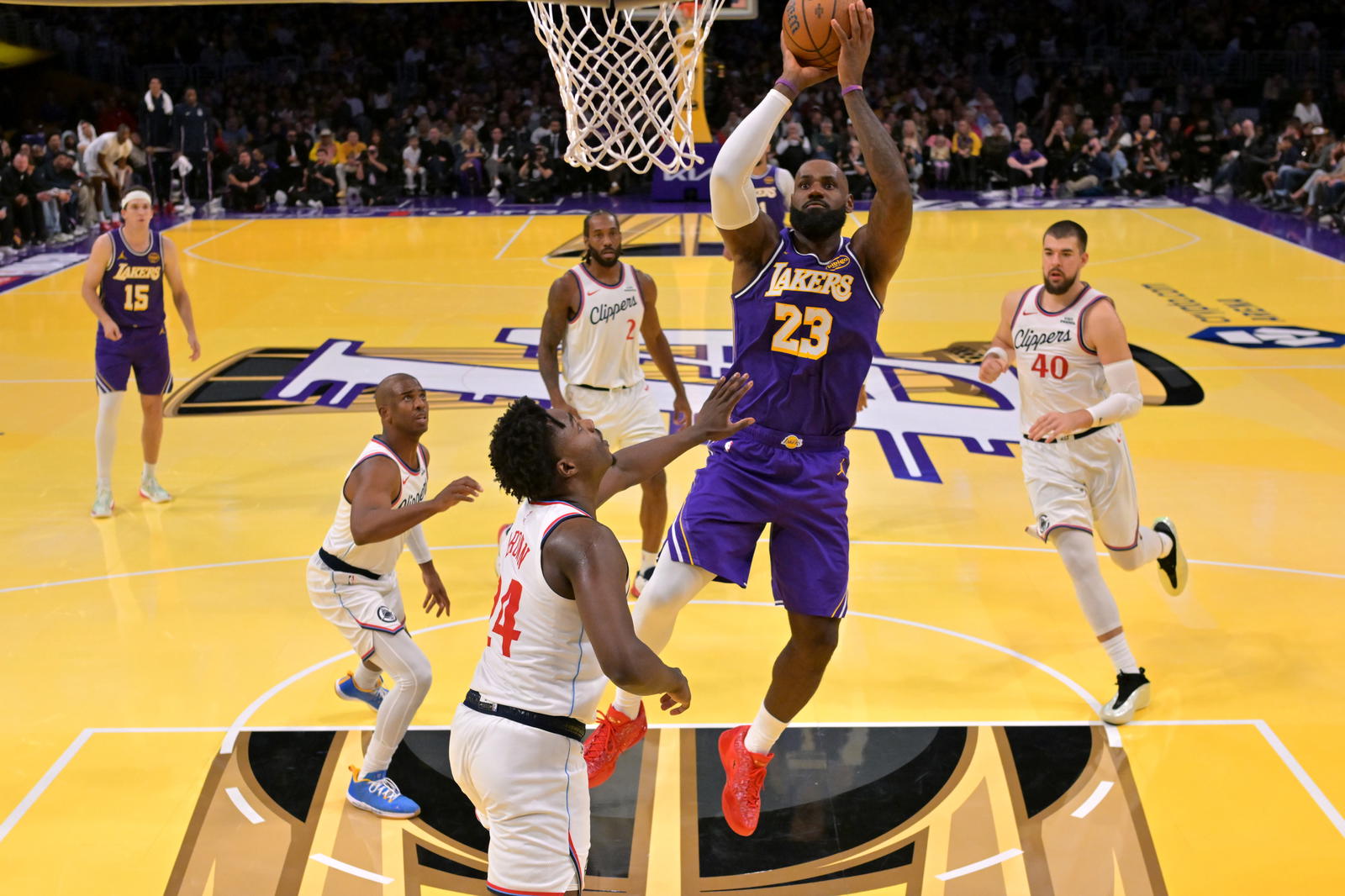 Los Angeles Lakers forward LeBron James (23) gets past Los Angeles Clippers guard Chris Paul (3), forward Kawhi Leonard (2), center Ivica Zubac (40) and guard Kobe Brown (24) for a basket in the second half at Crypto.com Arena. Jayne Kamin-Oncea-Imagn Images