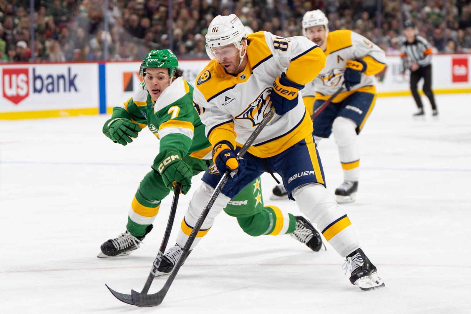 Dec. 31, 2024; Saint Paul, Minnesota, USA; Minnesota Wild defenseman Brock Faber (7) defends Nashville Predators center Jonathan Marchessault (81) in the first period at Xcel Energy Center. Mandatory Credit: Matt Blewett-Imagn Images