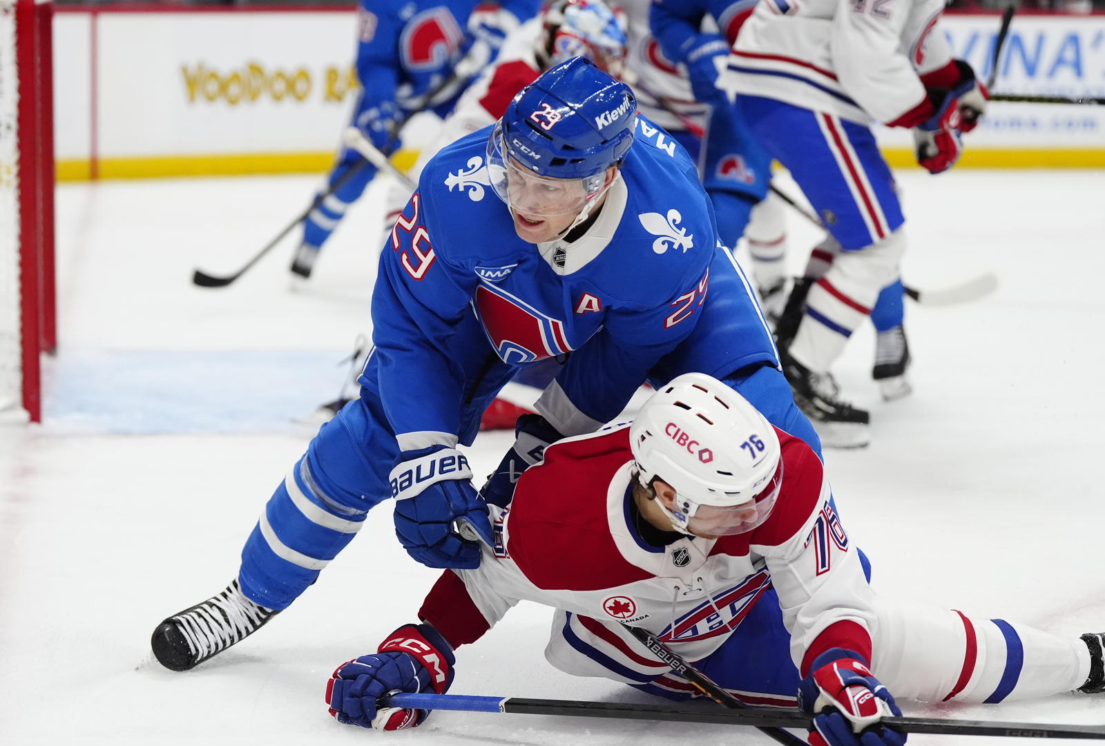 Credit: Ron Chenoy. Nathan MacKinnon takes down Zack Bolduc