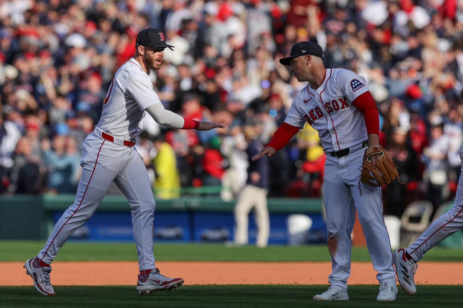 Apr 4, 2025; Boston, Massachusetts, USA; Boston Red Sox shortstop Trevor Story (10) celebrates with Boston Red Sox third baseman Alex Bregman (2) after defeating the St. Louis Cardinals at Fenway Park. (Paul Rutherford/Imagn Images)