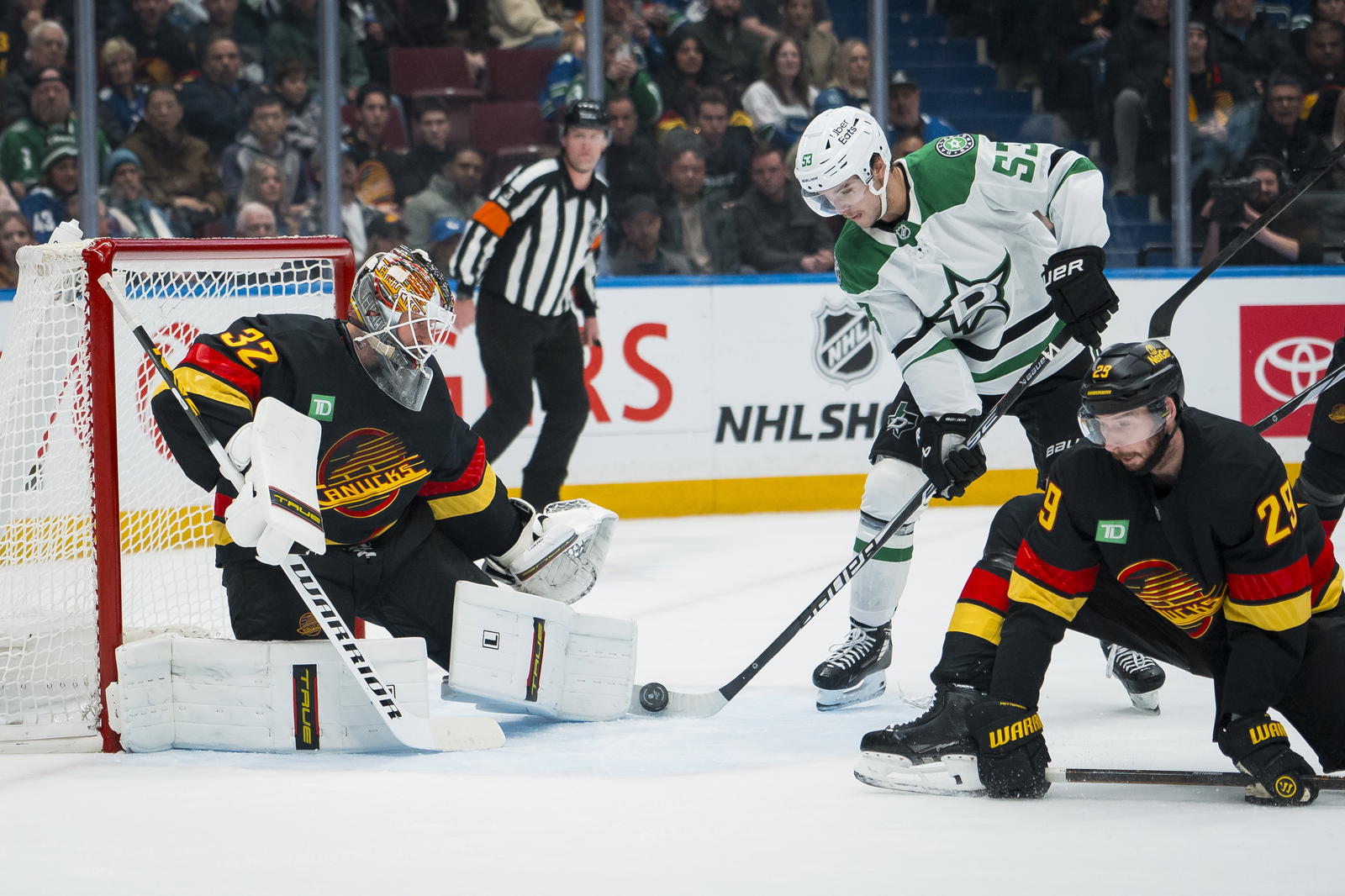 Nov 20, 2025; Vancouver, British Columbia, CAN; Vancouver Canucks defenseman Marcus Pettersson (29) watches as goalie Kevin Lankinen (32) makes a save on Dallas Stars forward Wyatt Johnston (53) in the first period at Rogers Arena. Mandatory Credit: Bob Frid-Imagn Images