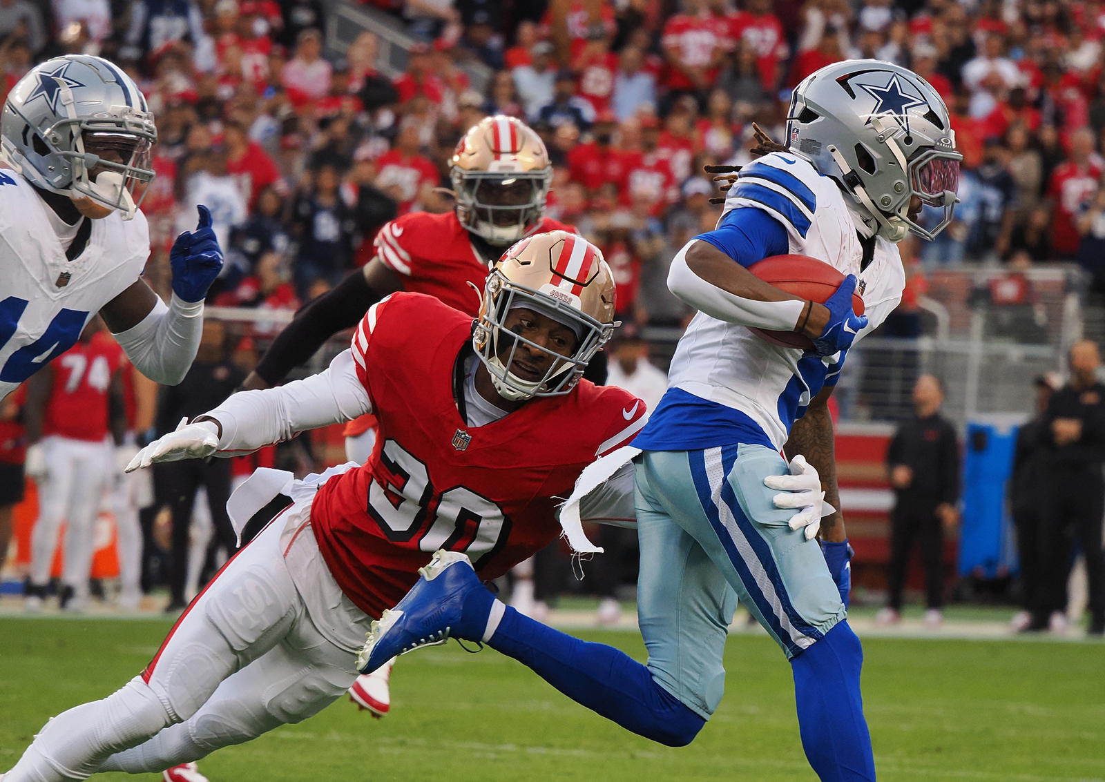 Oct 27, 2024; Santa Clara, California, USA; San Francisco 49ers safety George Odum (30) brings down Dallas Cowboys wide receiver KaVonte Turpin (9) on a kickoff return during the first quarter at Levi's Stadium. Mandatory Credit: Kelley L Cox-Imagn Images