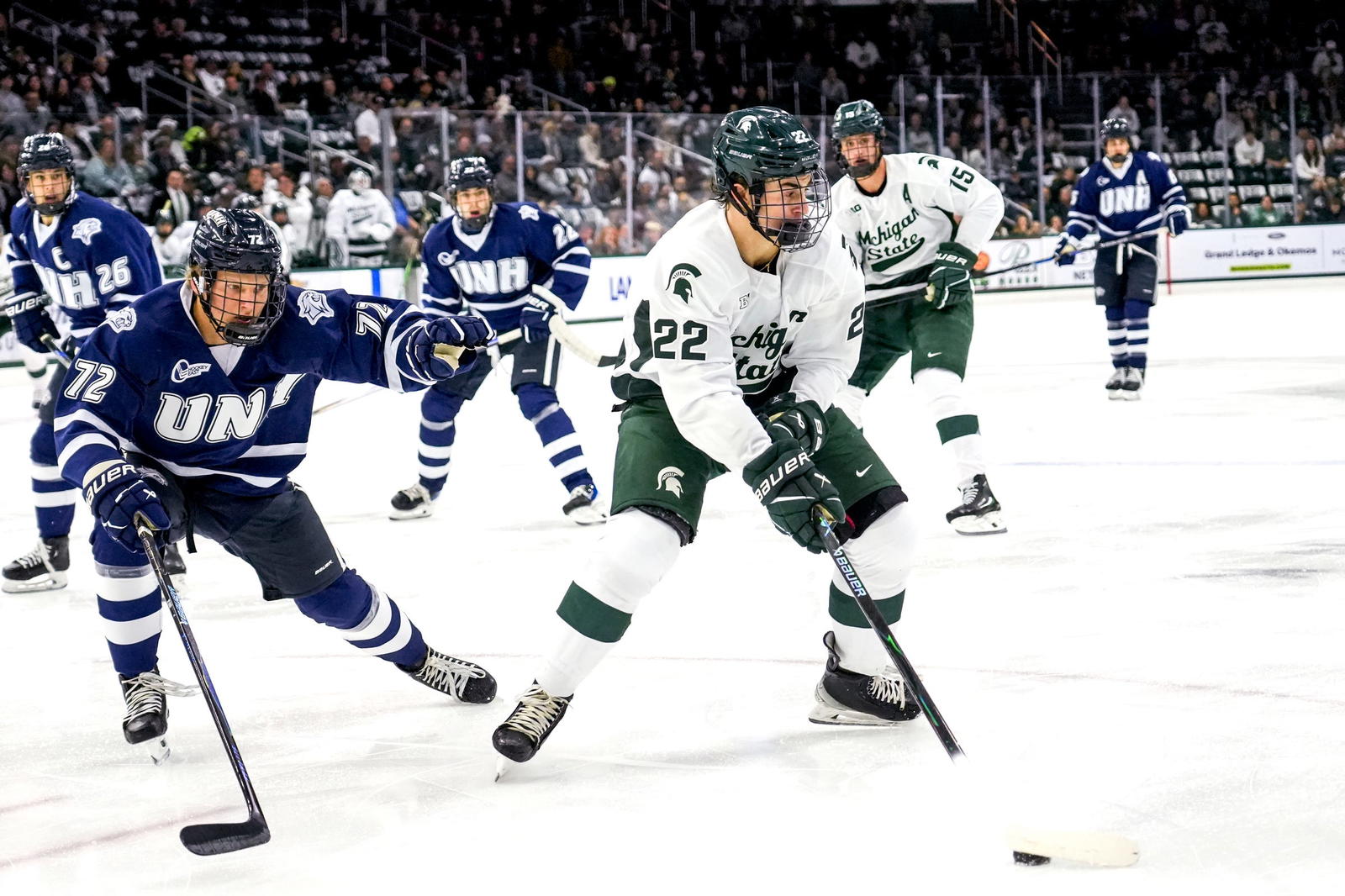 Michigan State's Porter Martone, right, moves the puck as New Hampshire's Conner de Haro closes in during the first period on Thursday, Oct. 9, 2025, at Munn Ice Arena in East Lansing.