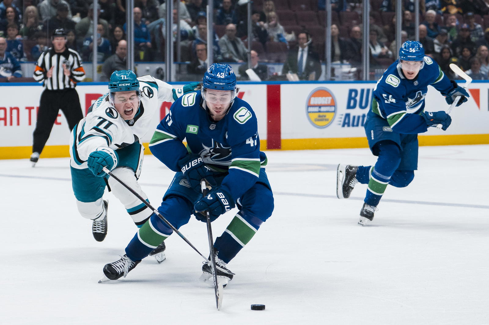 Apr 14, 2025; Vancouver, British Columbia, CAN; San Jose Sharks forward Macklin Celebrini (71) stick checks Vancouver Canucks defenseman Quinn Hughes (43) in overtime at Rogers Arena. Mandatory Credit: Bob Frid-Imagn Images
