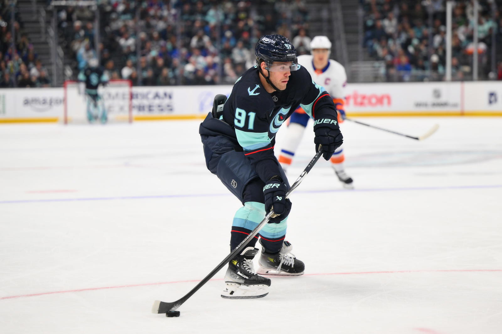 Seattle Kraken right wing Daniel Sprong (91) plays the puck during the first period against the New York Islanders at Climate Pledge Arena. Mandatory Credit: Steven Bisig-Imagn Images