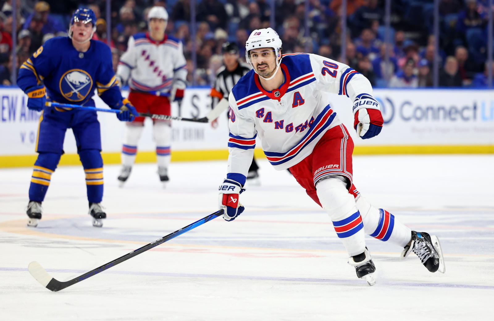 Dec 11, 2024; Buffalo, New York, USA; New York Rangers left wing Chris Kreider (20) looks for the puck during the third period against the Buffalo Sabres at KeyBank Center. Mandatory Credit: Timothy T. Ludwig-Imagn Images