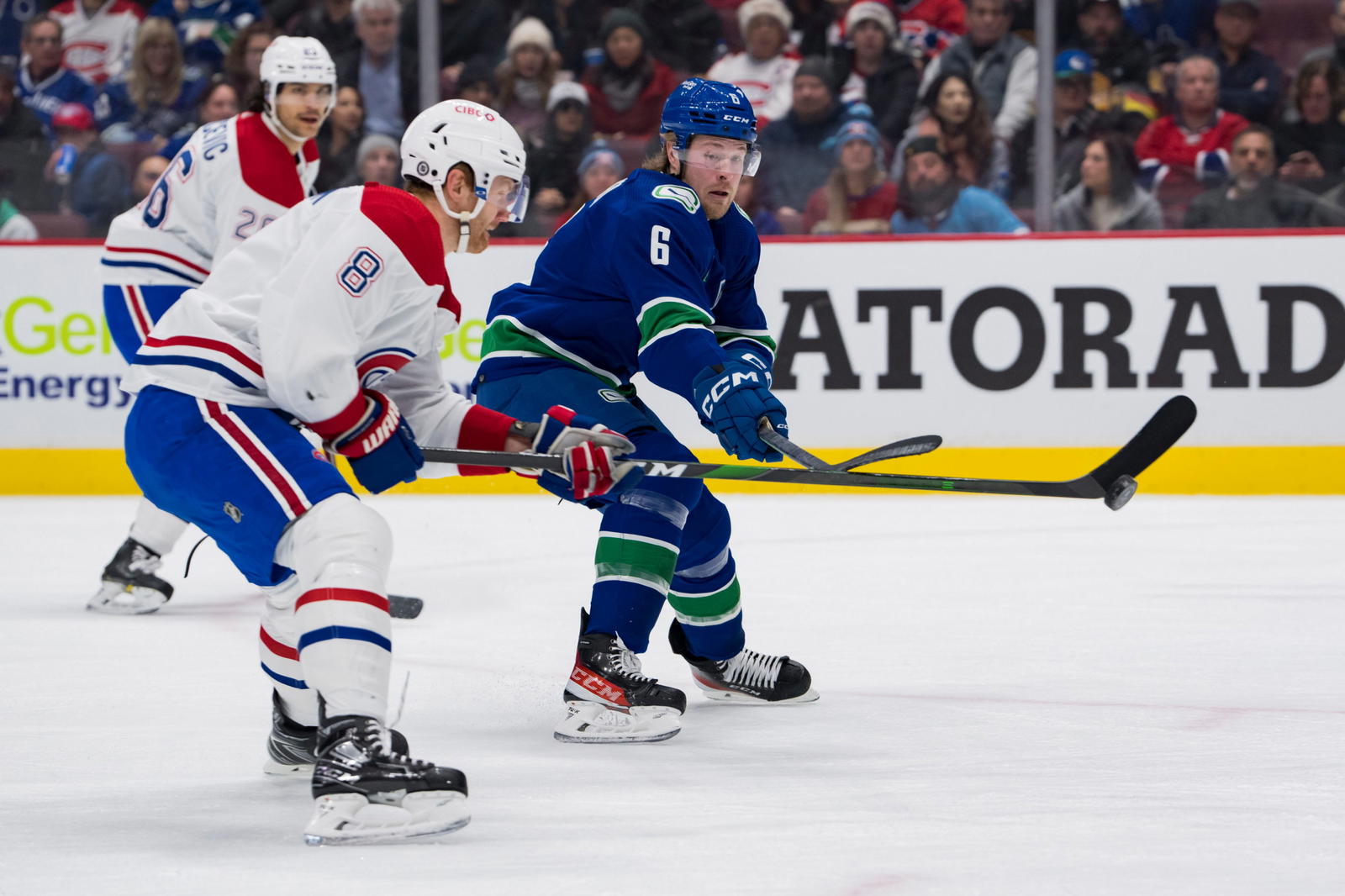 Dec 5, 2022; Vancouver, British Columbia, CAN; Montreal Canadiens defenseman Mike Matheson (8) and Vancouver Canucks forward Brock Boeser (6) reach for the loose puck in the first period at Rogers Arena. Mandatory Credit: Bob Frid-Imagn Images