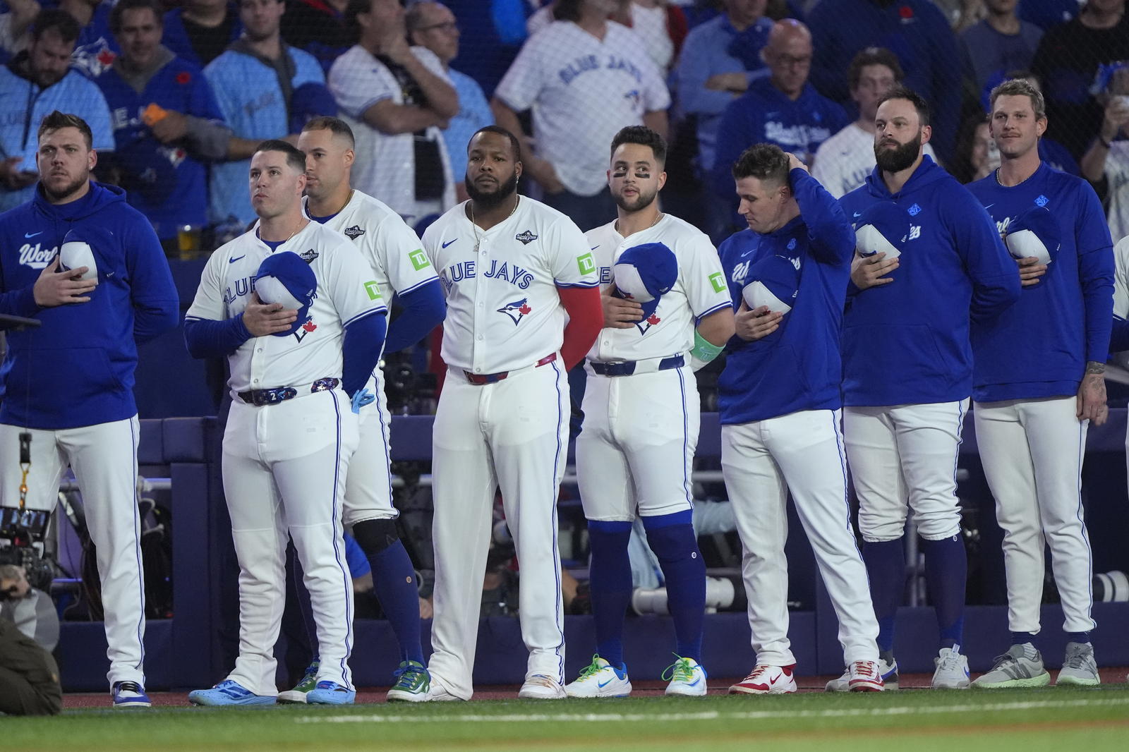 Toronto Blue Jays players line up during the national anthems before game seven of the 2025 MLB World Series against the Los Angeles Dodgers at Rogers Centre. John E. Sokolowski-Imagn Images