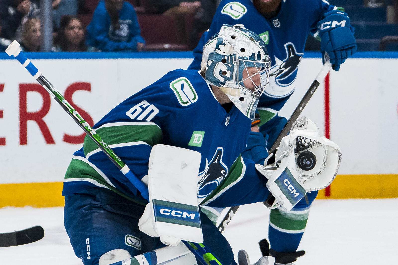 Apr 14, 2025; Vancouver, British Columbia, CAN; Vancouver Canucks goalie Nikita Tolopilo (60) makes a save against the San Jose Sharks in the third period at Rogers Arena. Mandatory Credit: Bob Frid-Imagn Images