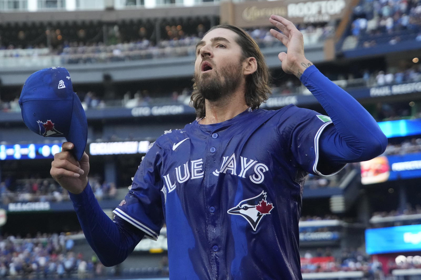 Toronto Blue Jays starting pitcher Kevin Gausman (34) reacts after getting doused with ice water and Gatorade after a complete game win over the Houston Astros at Rogers Centre. John E. Sokolowski-Imagn Images