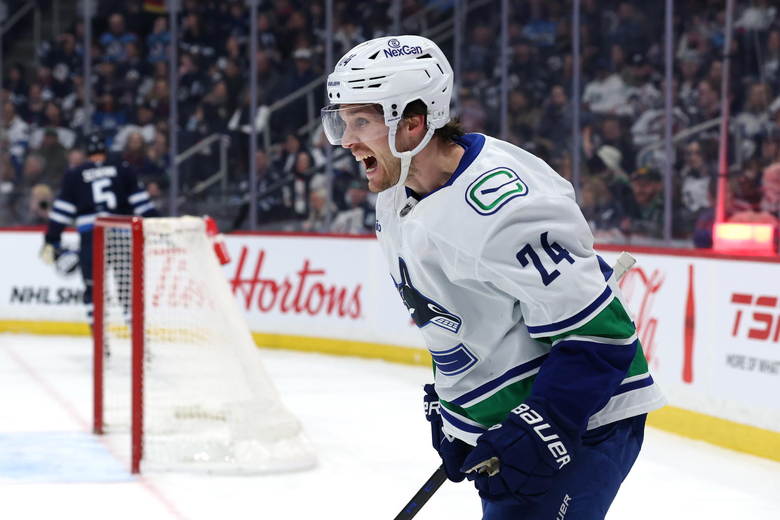 Mar 30, 2025; Winnipeg, Manitoba, CAN; Vancouver Canucks center Pius Suter (24) celebrates his goal against the Winnipeg Jets in the first period at Canada Life Centre. Mandatory Credit: James Carey Lauder-Imagn Images