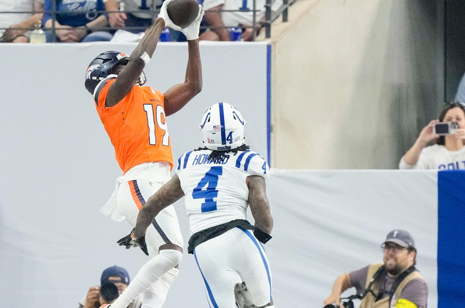 Denver Broncos wide receiver Marvin Mims Jr. (19) makes a catch for a touchdown as Indianapolis Colts cornerback Xavien Howard (4) gives chase Sunday, Sept. 14, 2025, during a game at Lucas Oil Stadium in Indianapolis. Mandatory Credit: Grace Hollars/IndyStar