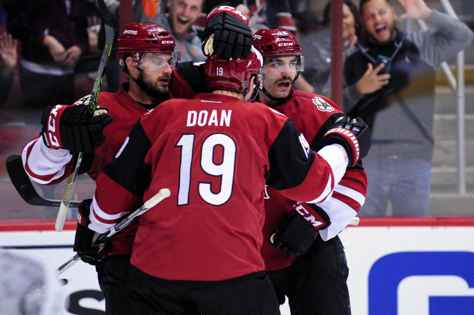 Dec 17, 2015; Glendale, AZ, USA; Arizona Coyotes left wing Jordan Martinook (48) celebrates with right wing Shane Doan (19) and center Brad Richardson (12) after scoring a goal in the second period against the Columbus Blue Jackets at Gila River Arena. (Matt Kartozian-Imagn Images)