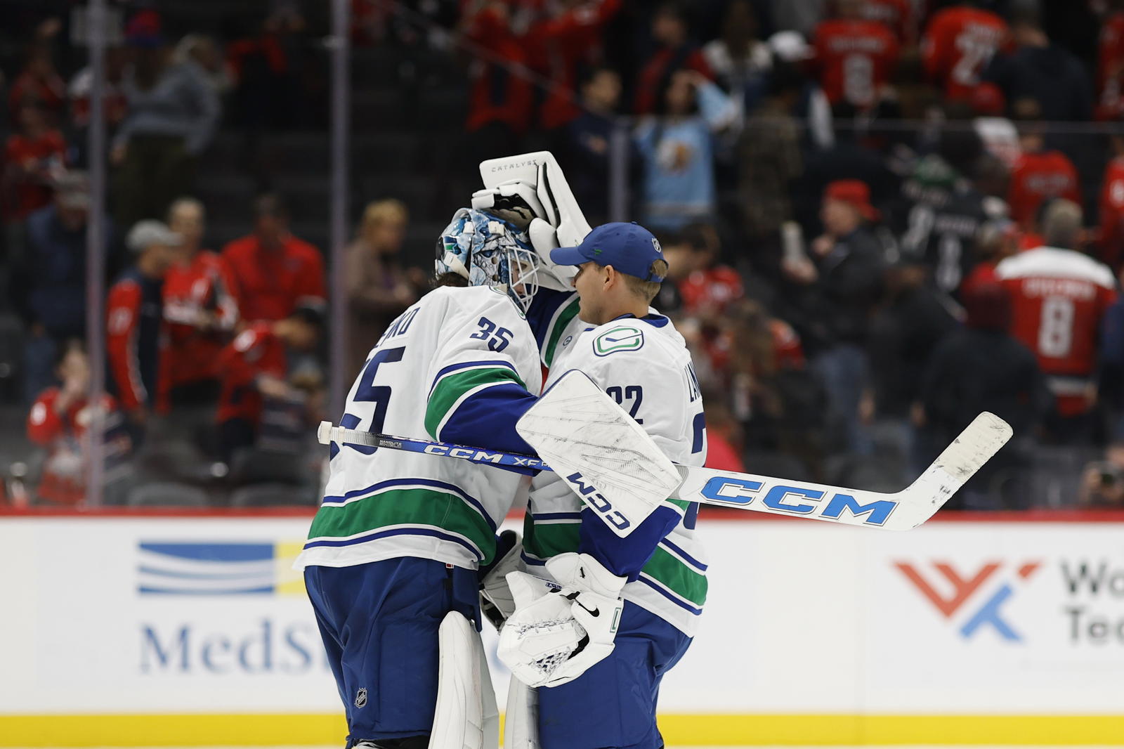 Oct 19, 2025; Washington, District of Columbia, USA; Vancouver Canucks goaltender Thatcher Demko (35) celebrates with Canucks goaltender Kevin Lankinen (32) after their game against the Washington Capitals at Capital One Arena. Mandatory Credit: Geoff Burke-Imagn Images